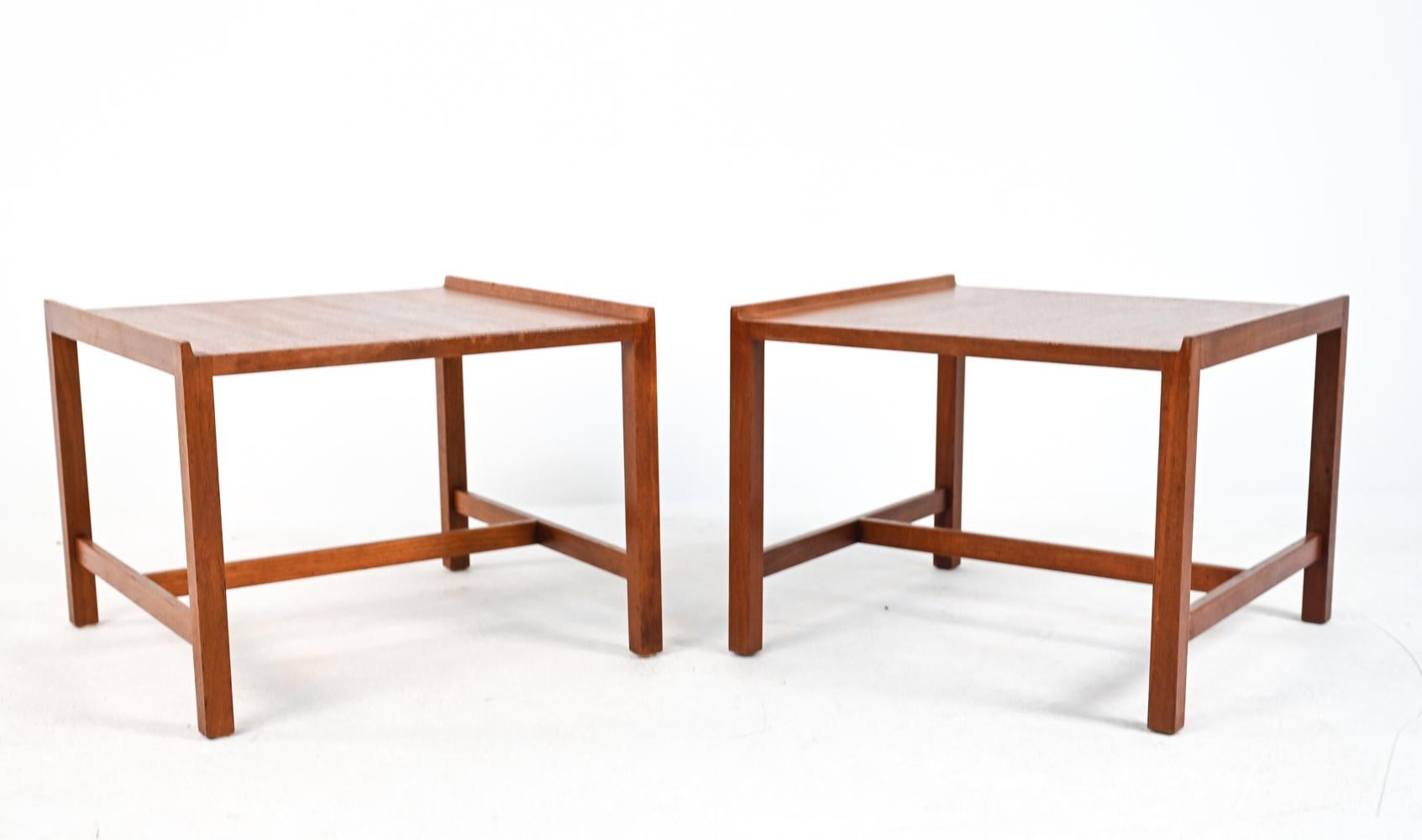A handsome pair of Danish mid-century side tables in teak wood, with a clean, minimalist design by Illums Bolighus.