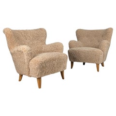 Coppia di poltrone Ilmari Lappalainen modello 238 in pelle di pecora, Asko anni '40