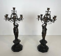 Pair of Important Candelabra in Patinated Bronze Presenting Caryatids Carrying