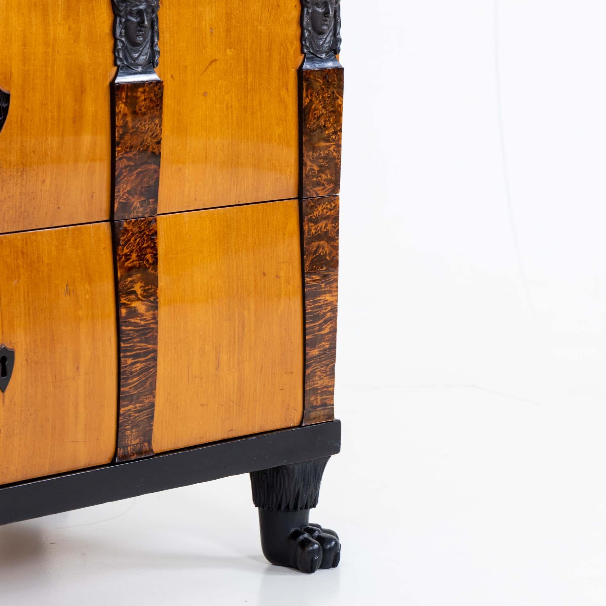 A pair of Important chests in maple with burl veneer and ebonized details. Extraordinarily crafted Berlin cast iron intricate designs and four caryatids on the front of each chest. Resting on four ebonzied paw feet.