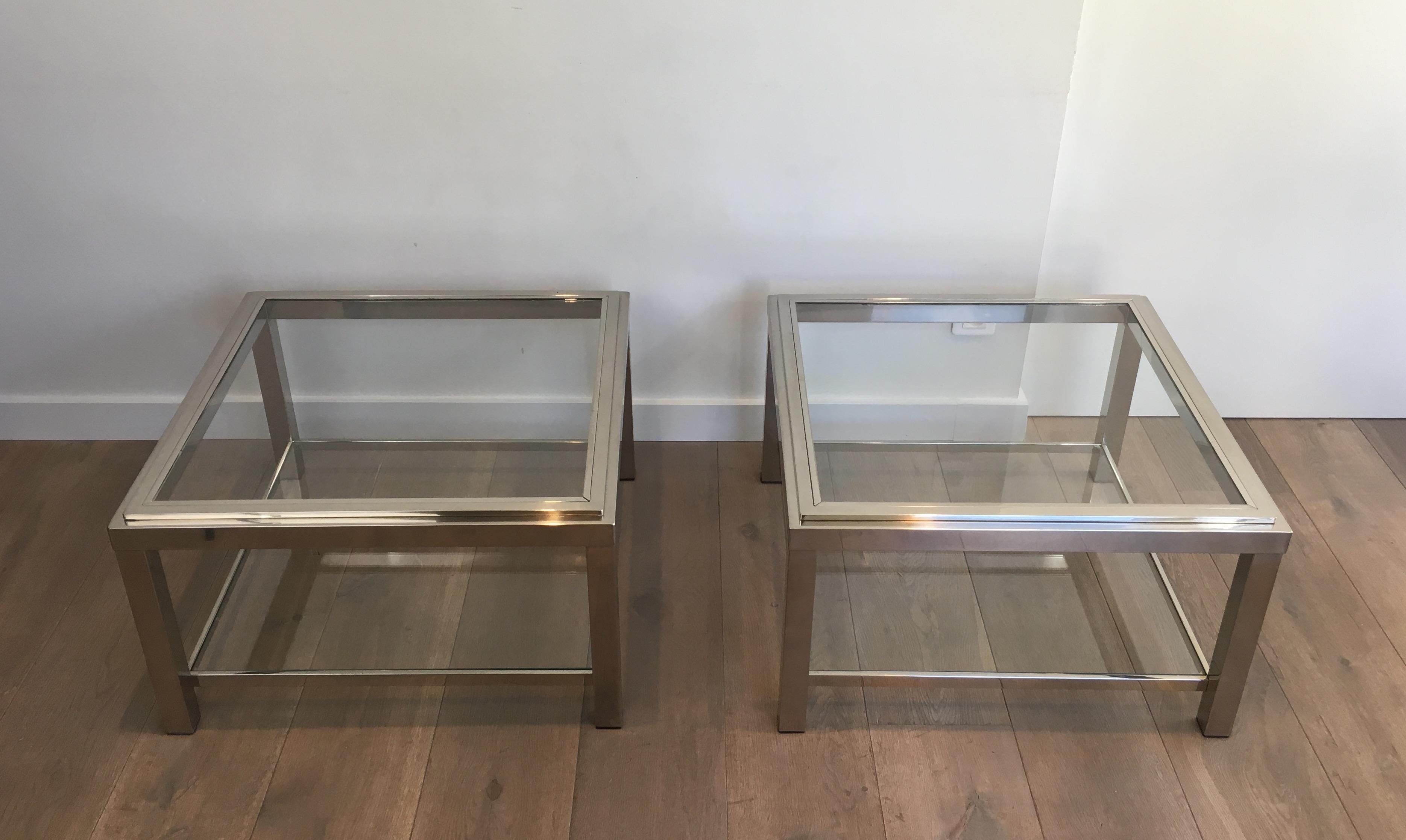 This large pair of side tables is made of chromed with glass shelves. The top glass shelves are inserted in a chromed frame. This is a very nice quality. This is a French work, circa 1970.