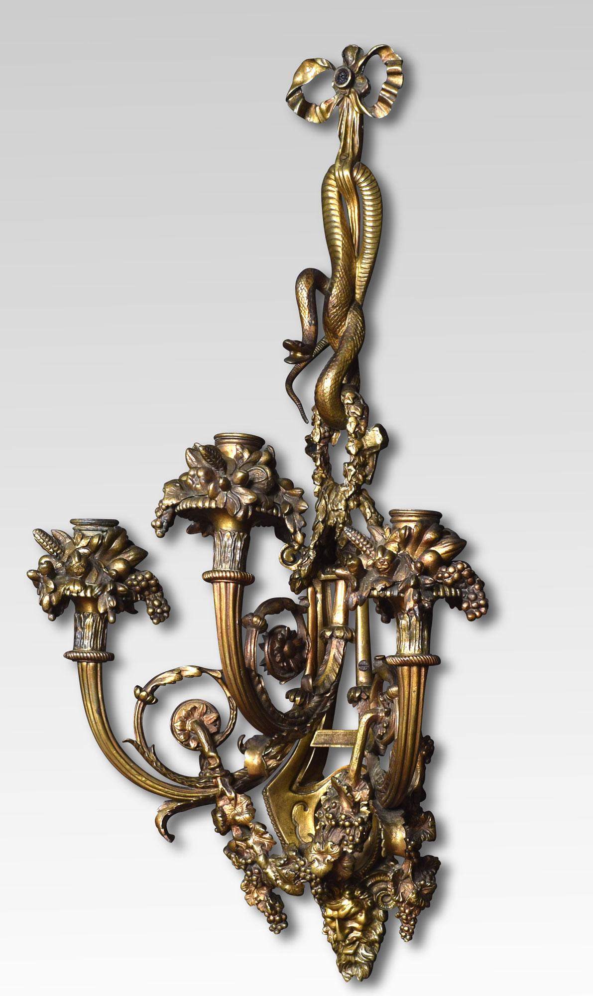 Pair of important impressive large scale mid-19th century French Louis XIV style gilt bronze three arm sconces. The richly designed pair with all original gilt having unusual serpent decoration above three scrolling arms with floral relief