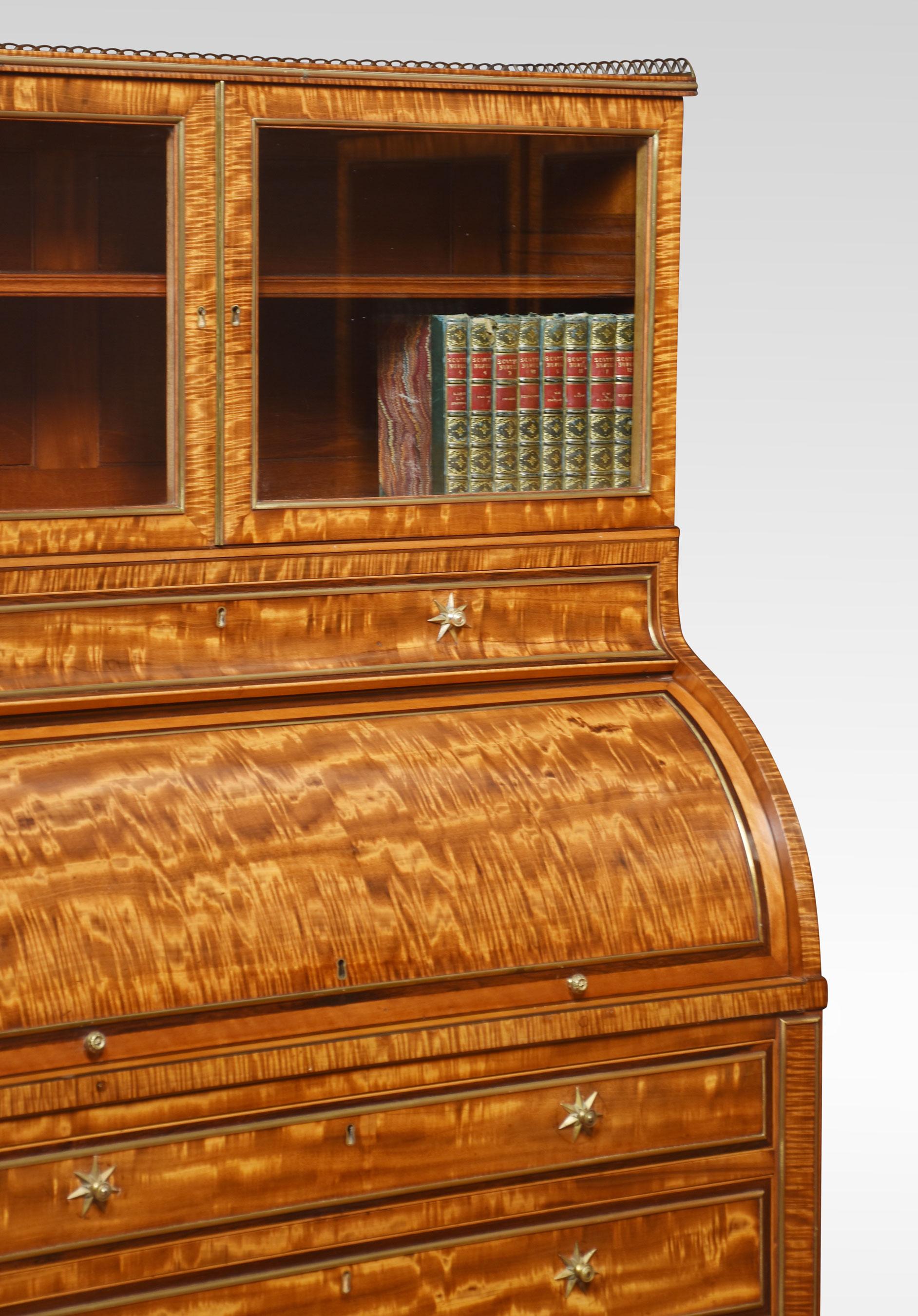 Pair of Georgian cylinder cabinets / bookcases, the raised pierced gallery, and well-figured satinwood tops to the glazed doors opening to reveal an adjustable shelf. The freize having cylinder fronts opening to reveal the fitted interior and inset