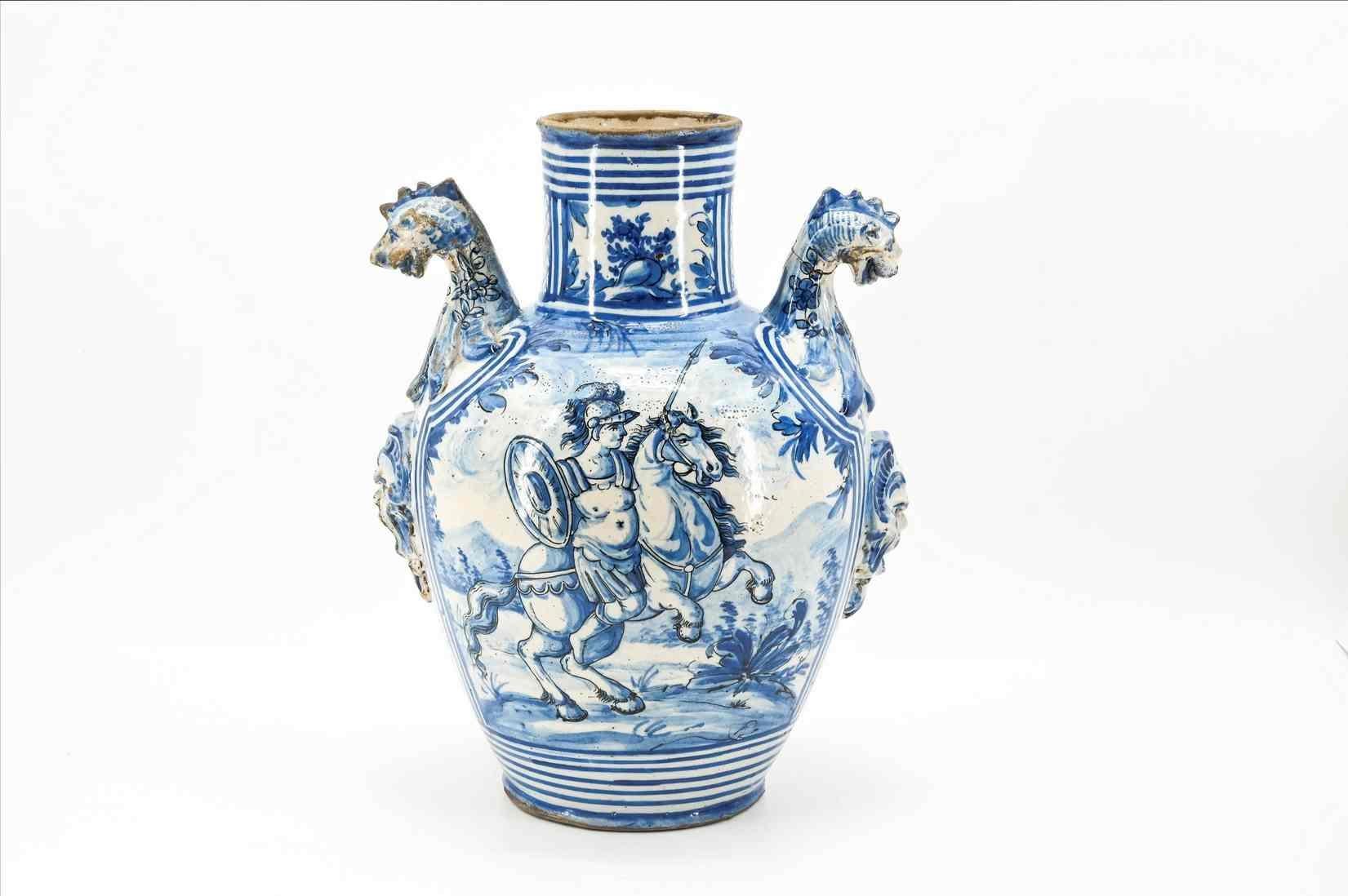 Large and important pair of vases from the Savona factory. Both vases have side handles ending in dragons. The reserves on the side are decorated with figurative scenes and architectural veduttes. They have slight knocks due to the enamel and the