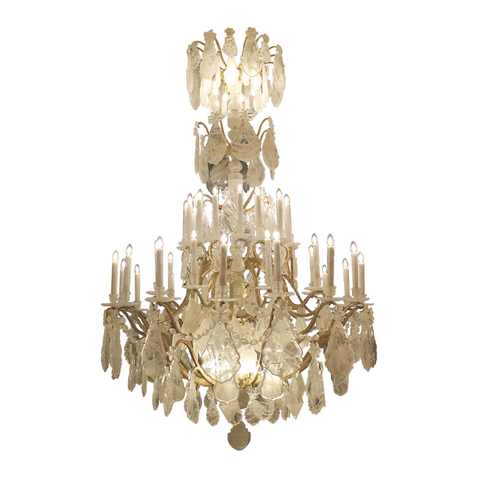 Pair of grand rock crystal chandeliers in the Louis XV style. Original circa 1910 Gilt bronze frame with 80 lights, with an antique finish, redressed in rock crystal by Dimitri Stefanov. Dimensions : Height 300 cm x 180 cm diameter.  

All redressed