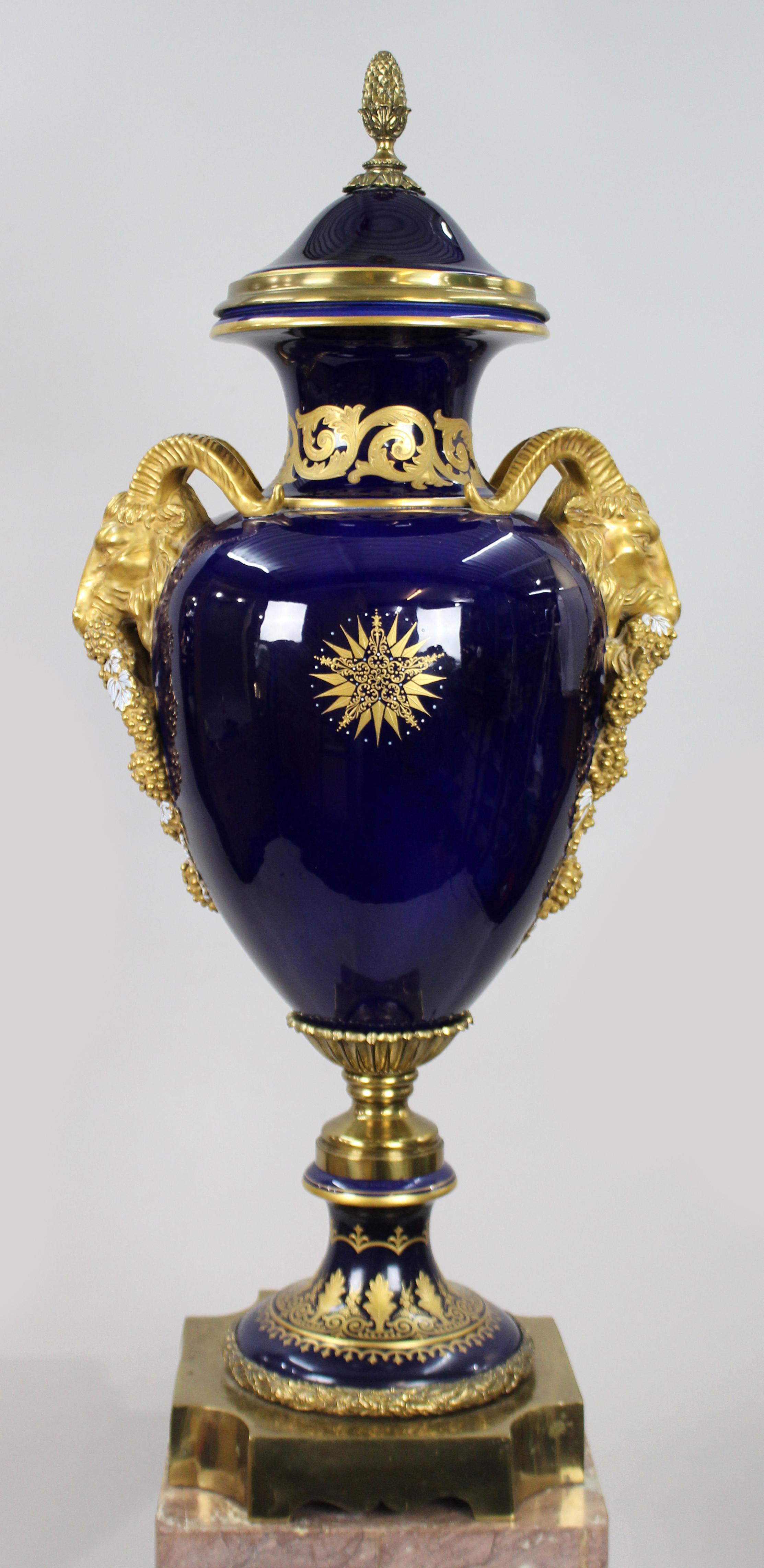XX secolo Pair of Impressive Cobalt Blue Gilt Rams Head Lidded Urns in vendita