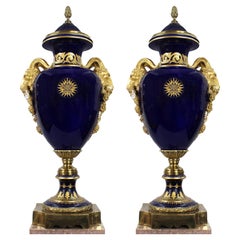 Pair of Impressive Cobalt Blue Gilt Rams Head Lidded Urns