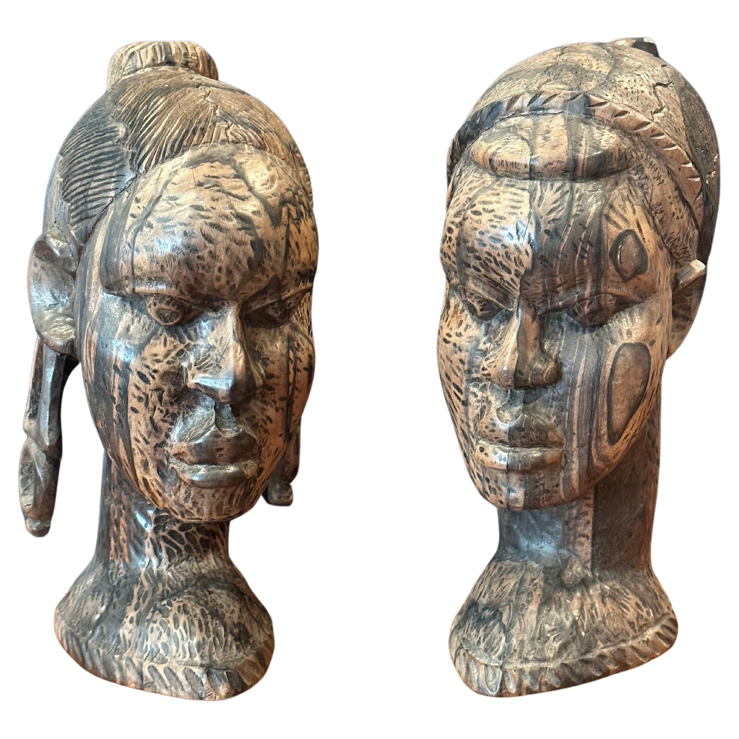 An impressive pair of hand-carved hardwood African busts, circa 1970s. The pair are made out of some type of exotic hardwood (zebra wood? very heavy and dense) and have an amazing look.  Each bust is in very good condition with no chips and measures