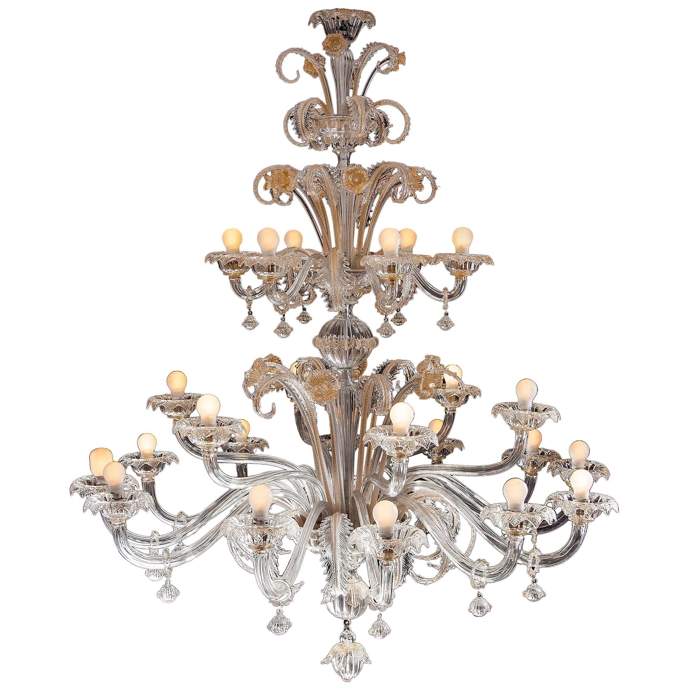 Spectacular pair of Murano chandeliers. The arms 24 are arranged on three floors. The glasses are embellished with gold inclusions.
 Provenance from an important Roman palace.