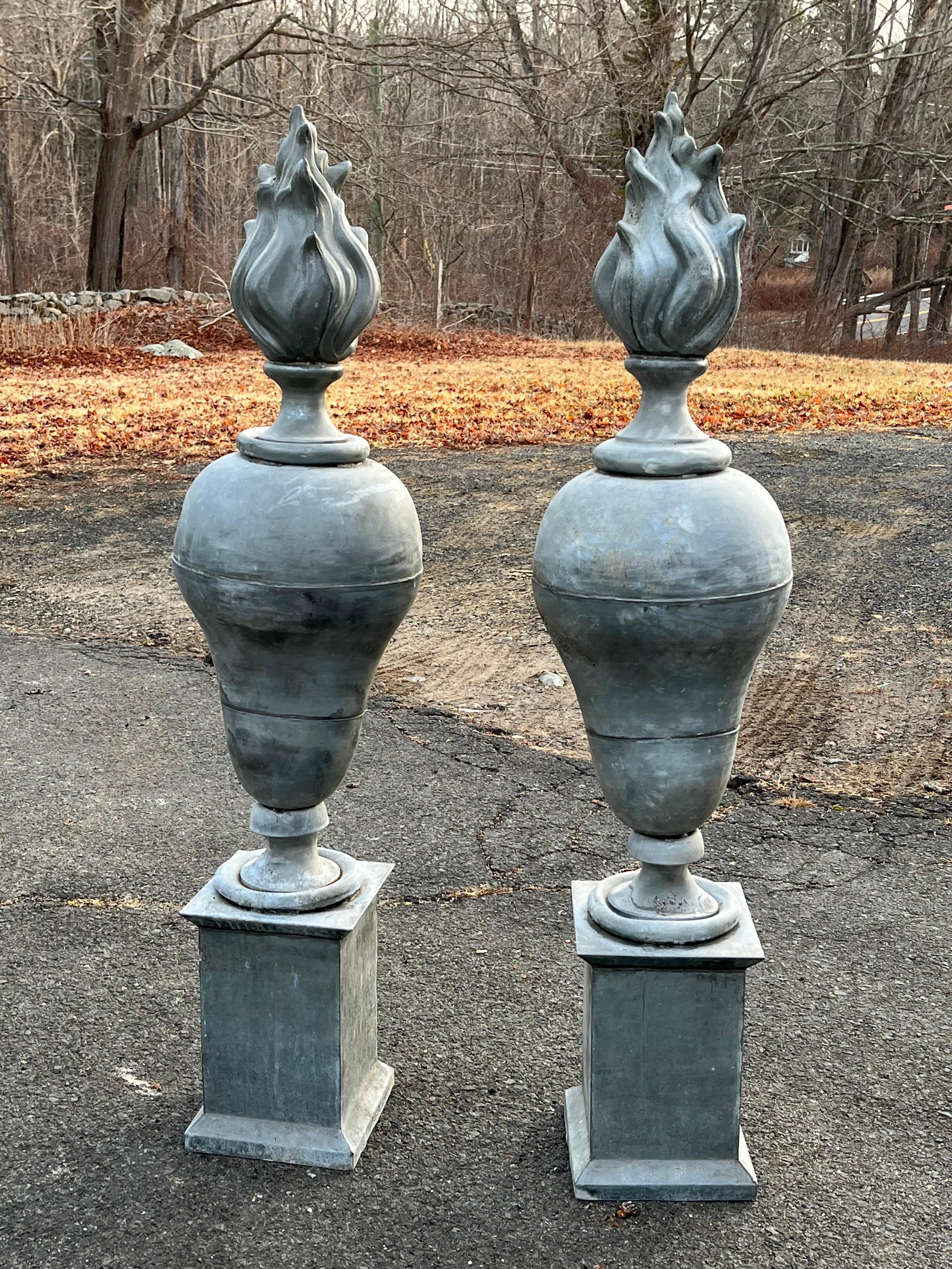 A pair of impressive size zinc urn-form architectural finials with flame tops and square bases, mid 19th century French.
A near identical pair was sold at Stair Galleries 9/08/22 lot #0066.
Naturally patinated, each in 2 parts.