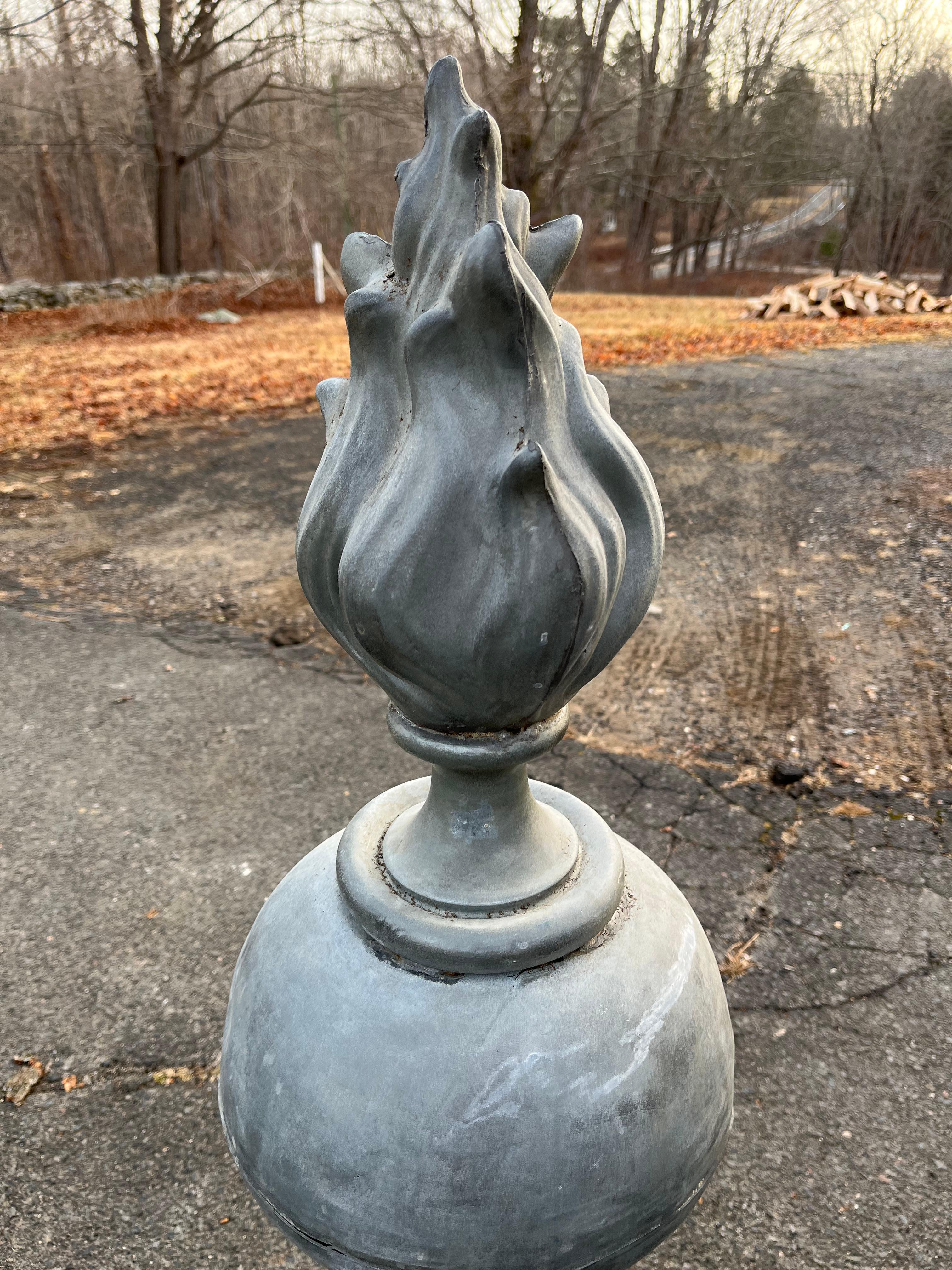 A pair of impressive size zinc urn-form architectural finials with flame tops and square bases, Mid-19th Century French.
A near identical pair was sold at Stair Galleries 9/08/22 lot #0066.
Naturally patinated, each in 2 parts.