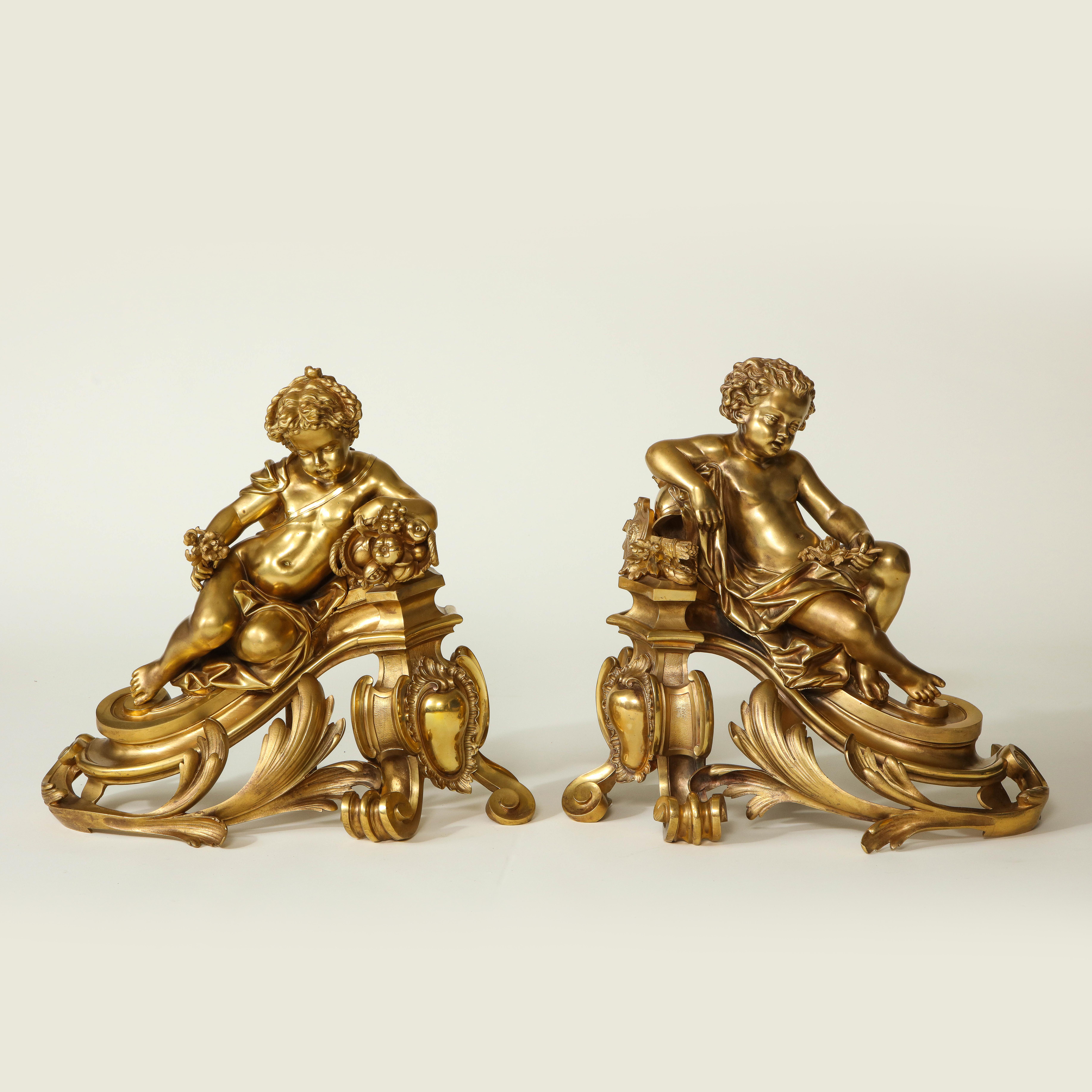 Conceived in the Louis XV style with rocaille decoration and featuring two reclining putti, one with a cornucopia of fruit and the other with a sling of arrows, each holding a floral bouquet.