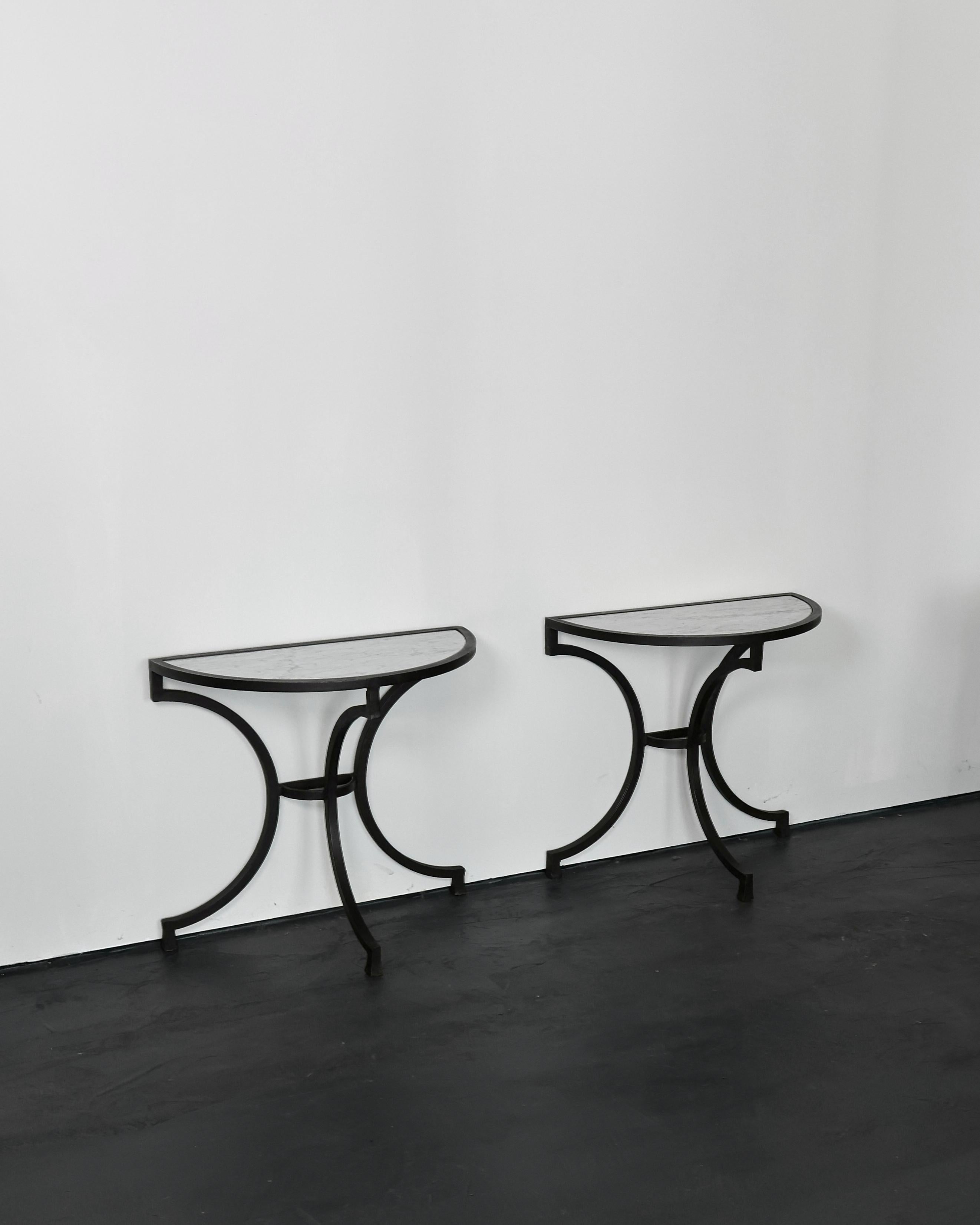 A pair of very high quality forged iron & carrara marble demi lune console tables from Andalusia, Spain.

C.1960s with light wear and beautiful dark patina to the iron.

