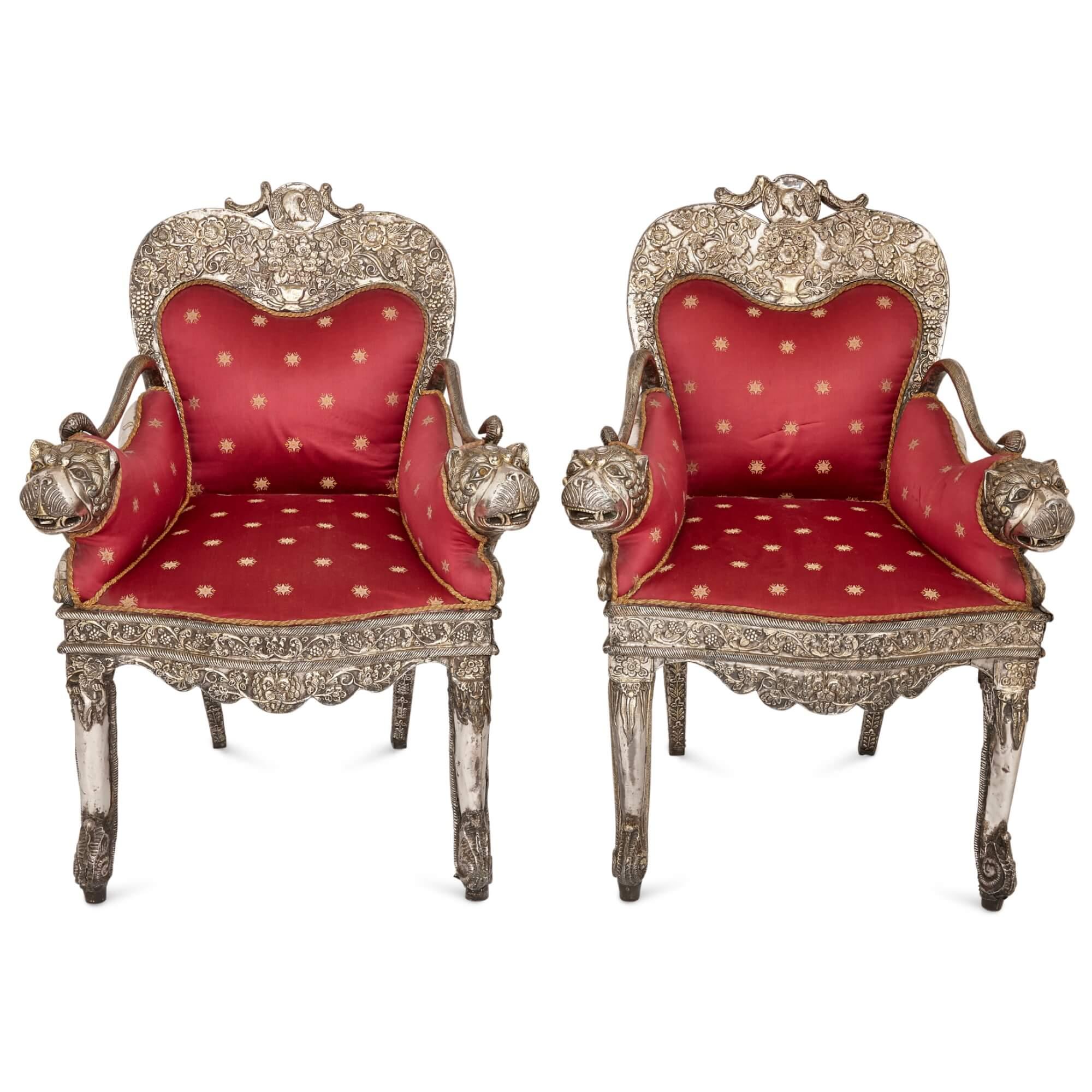 Pair of Indian repoussé silver upholstered chairs 
Indian, 19th Century 
Height 97cm, width 71cm, depth 62cm

Made from silver in 19th century India, this pair of chairs is adorned with a plethora of complex motifs and is a demonstration of the