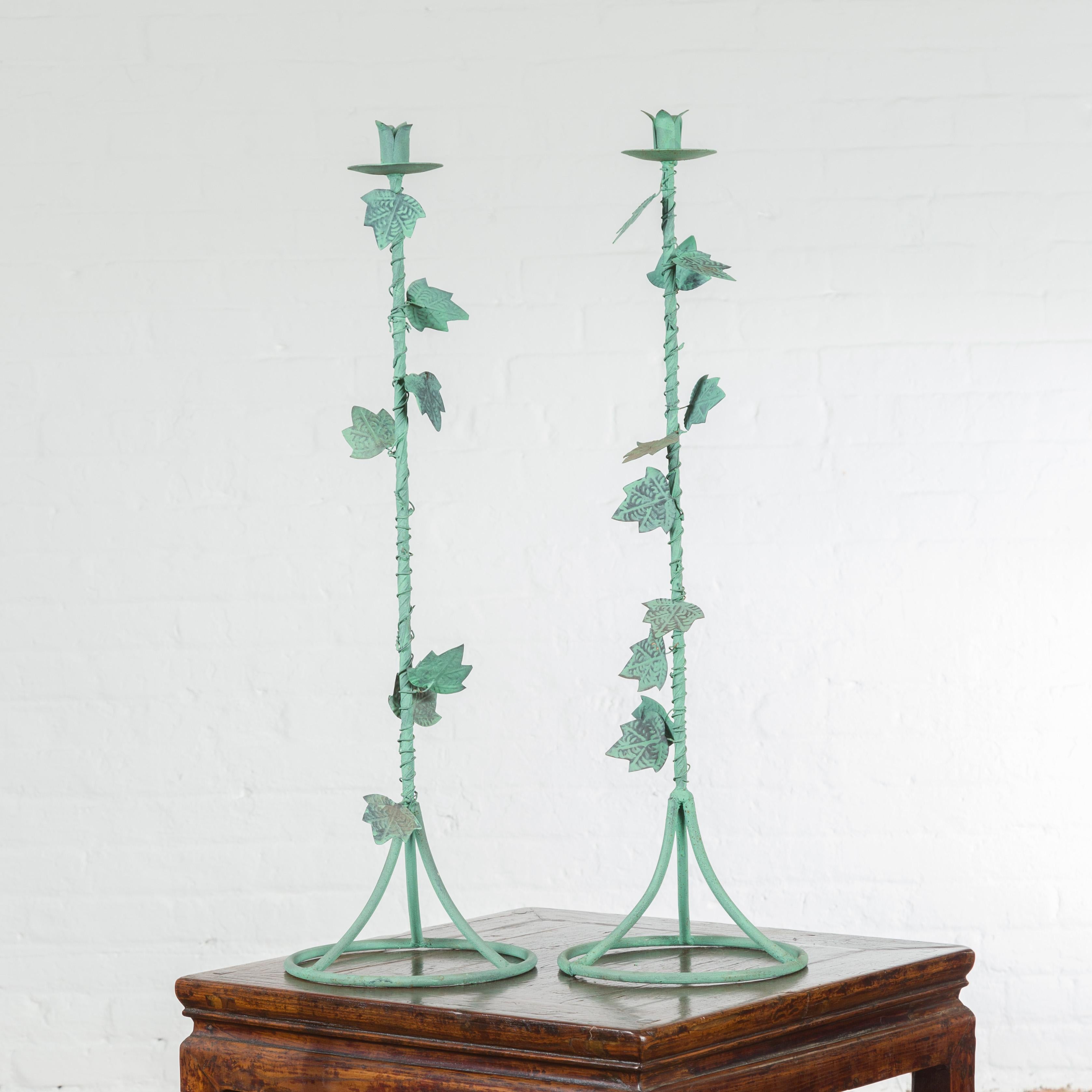 A pair of Indian vintage brass candlesticks from the mid 20th century, with foliage and verde patina. We currently have three pairs available, priced and sold $195 each pair. Charming us with their delicate lines and verde patina, this pair of