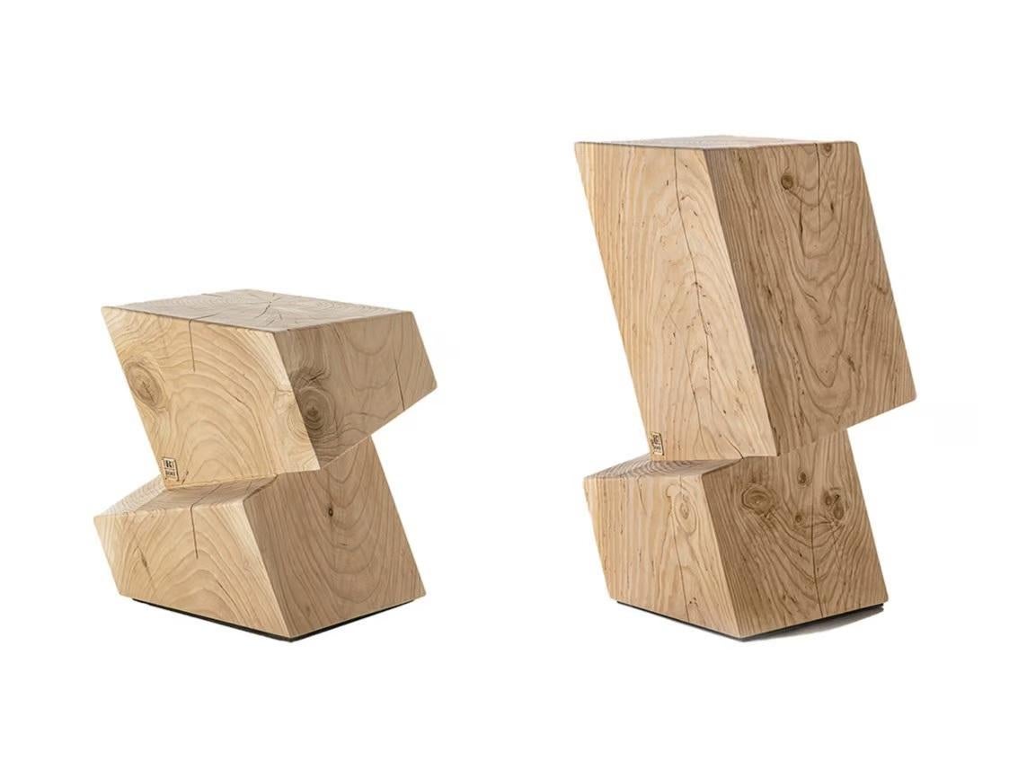The Rotterdam high stool from Riva 1920, designed by Giovanni Tomasini, stands out for its unique and nonconformist design inspired by the cubic houses of Dutch architect Piet Blom. This stool is meticulously carved from a single block of scented