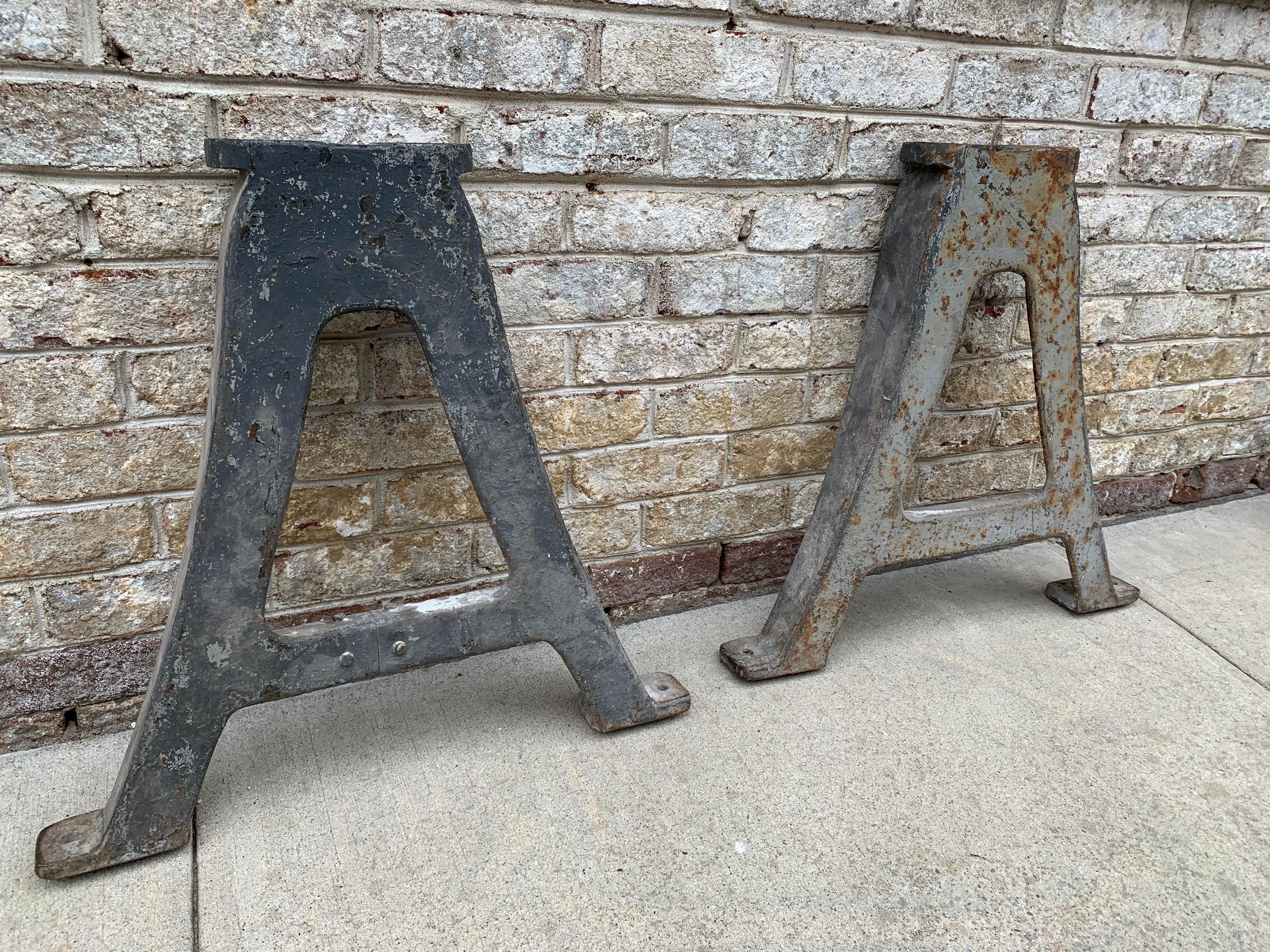 Late 19th century and possibly by Adams Brothers Foundries made of cast iron. These two A-shaped heavy leg bases will hold any heavy marble, slate or wood top perfectly for your design needs. In as-found condition, showing heavy paint distress and