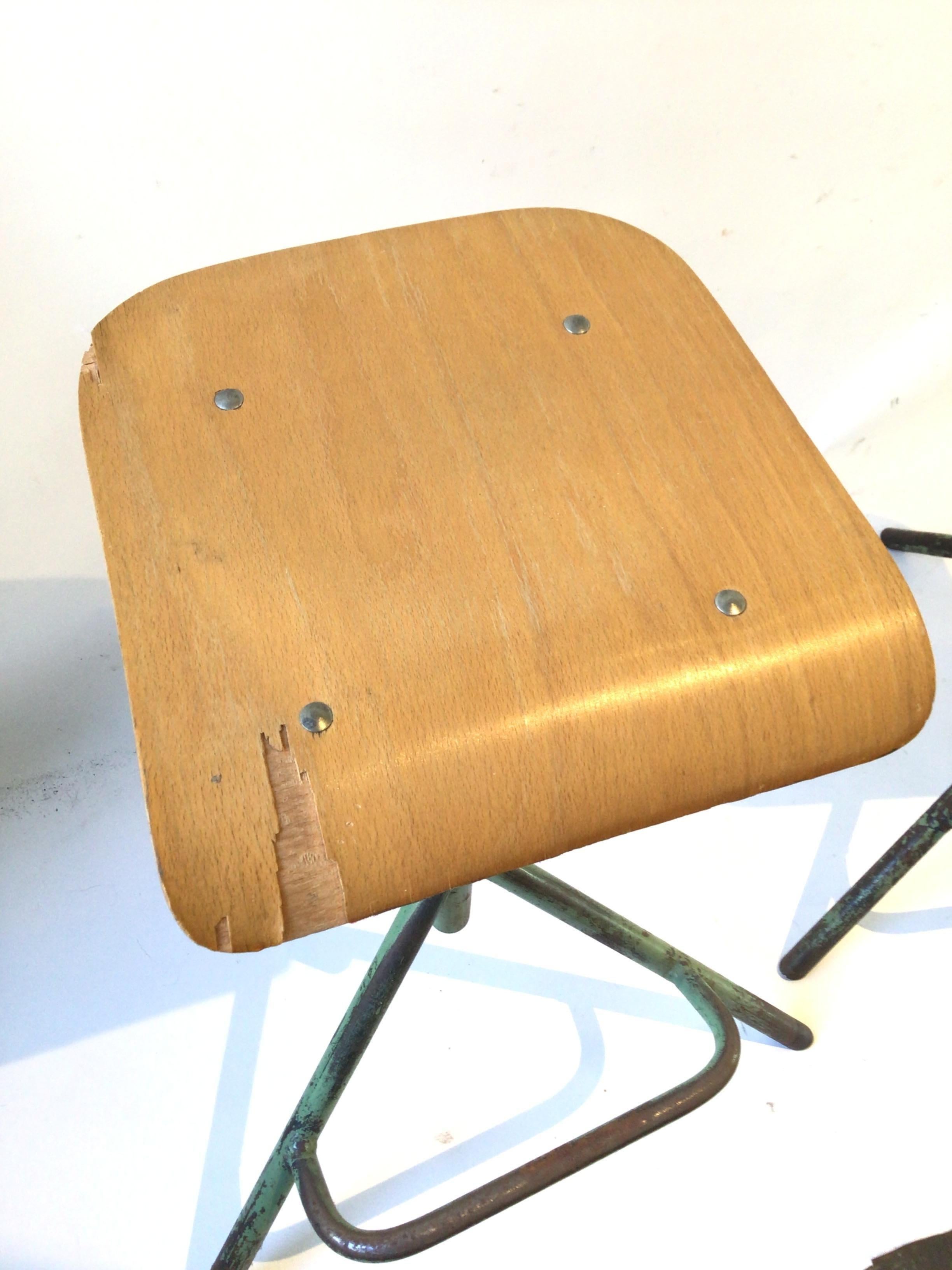 Pair of 1940s Industrial adjustable stools. Wood seats, iron bases. Chips in wood on one seat as shown in pictures.
This item can be shipped through UPS.