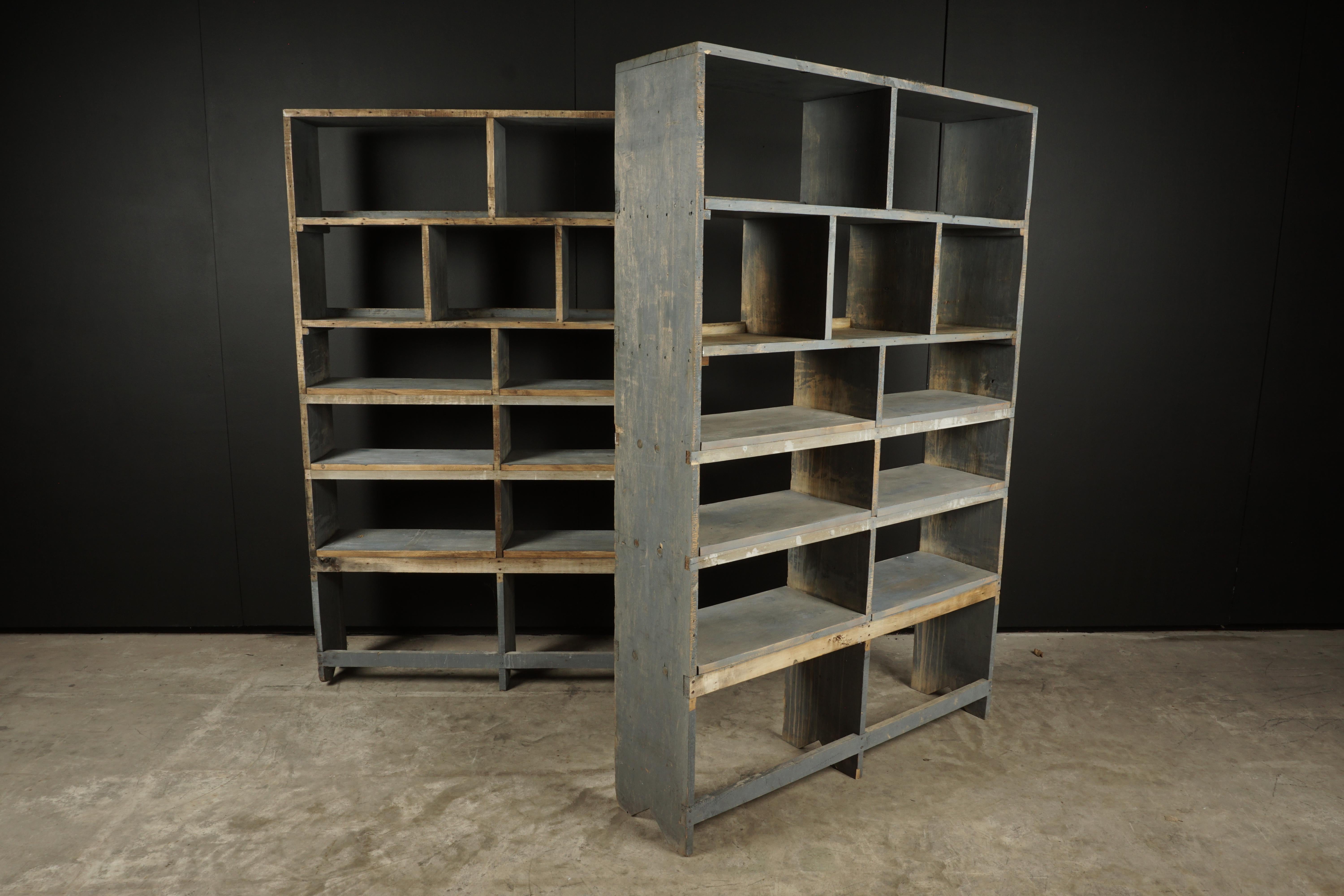 Pair of vintage industrial bookcases from France, circa 1940. Solid pine construction with nice original blue paint.