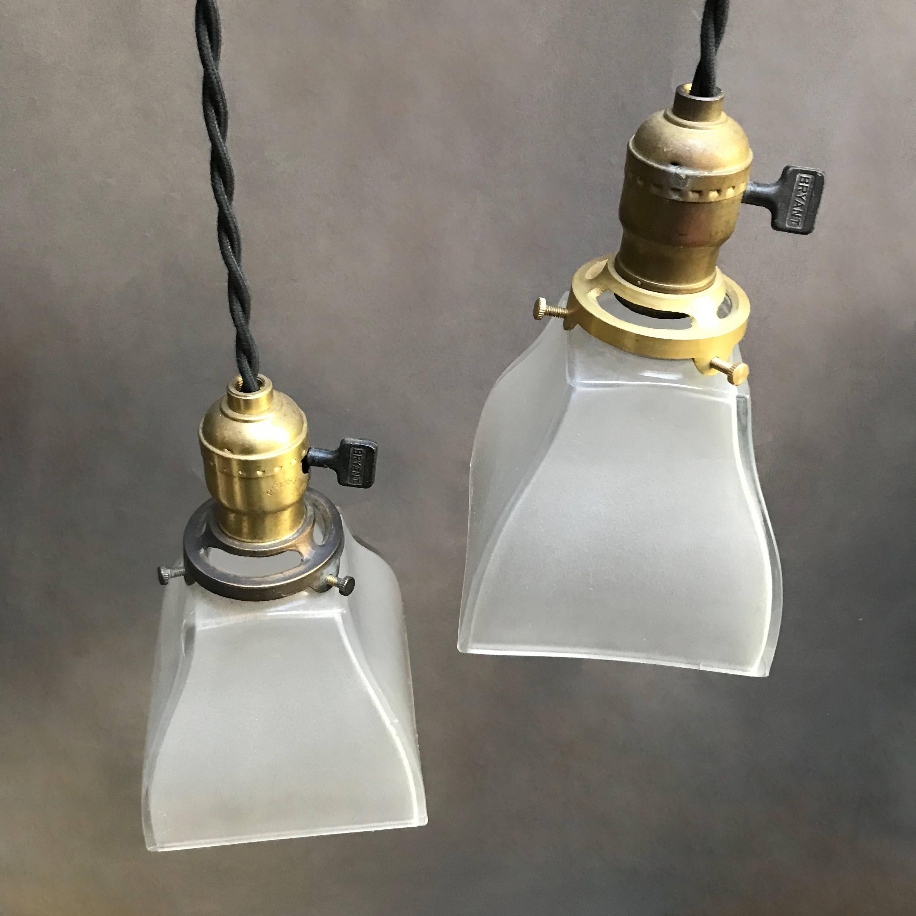 Américain Paire de lampes à suspension industrielles en verre dépoli et laiton en vente