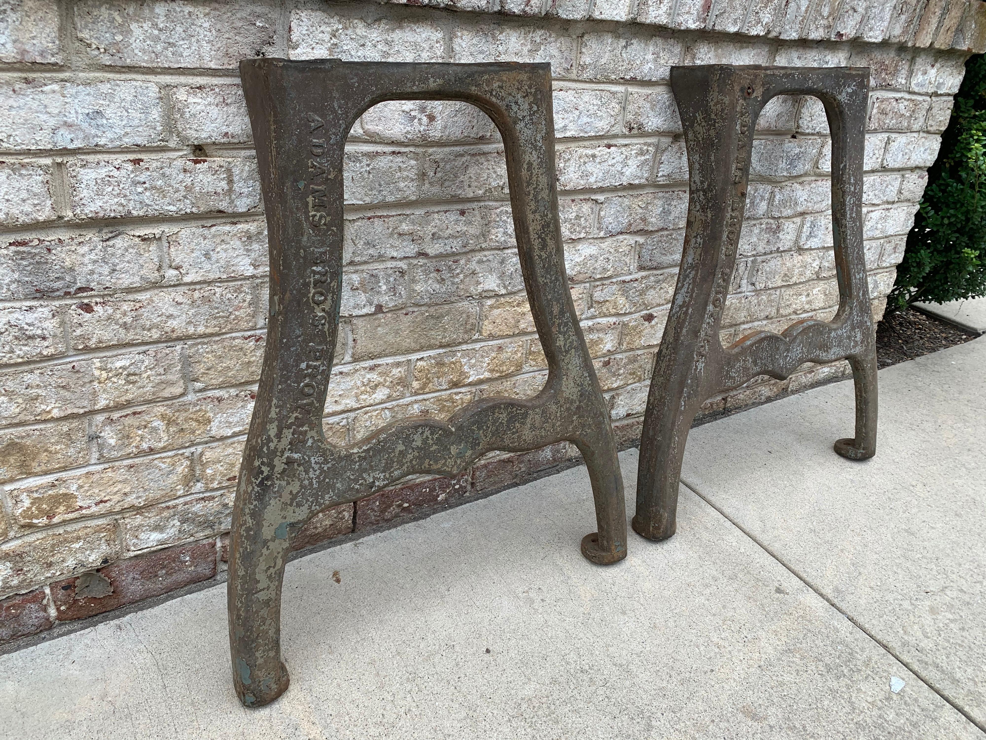 Late 19th century made by Adams Brothers foundries made of cast iron. These two heavy leg bases will hold any heavy marble, slate or wood top perfectly for your design needs. These are perfect for desk or standard table height. In as-found