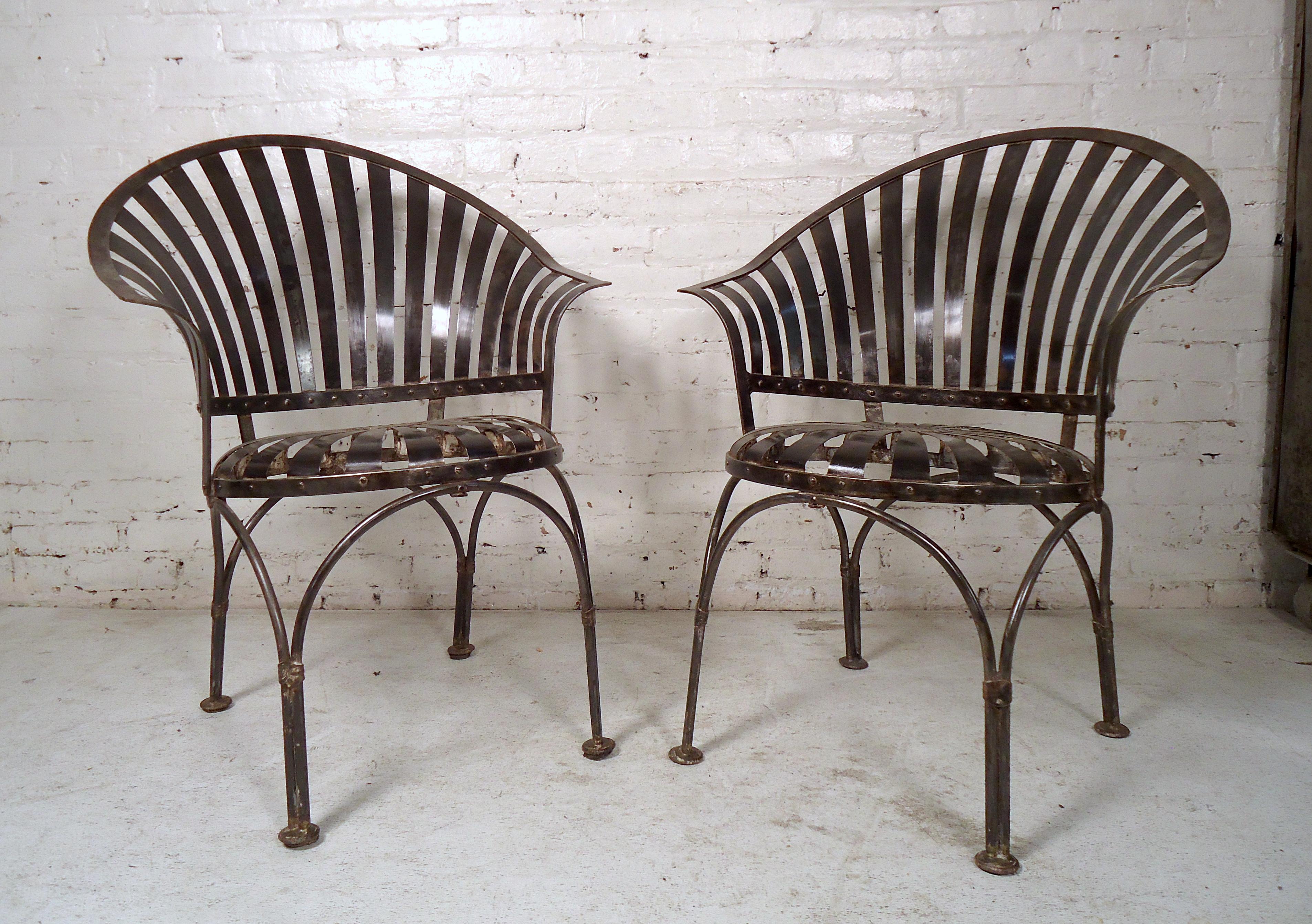 Vintage industrial metal chairs featuring a bent metal slat back, round seat, and sturdy legs in a bare metal finish.

(Please confirm item location, NY or NJ, with dealer).