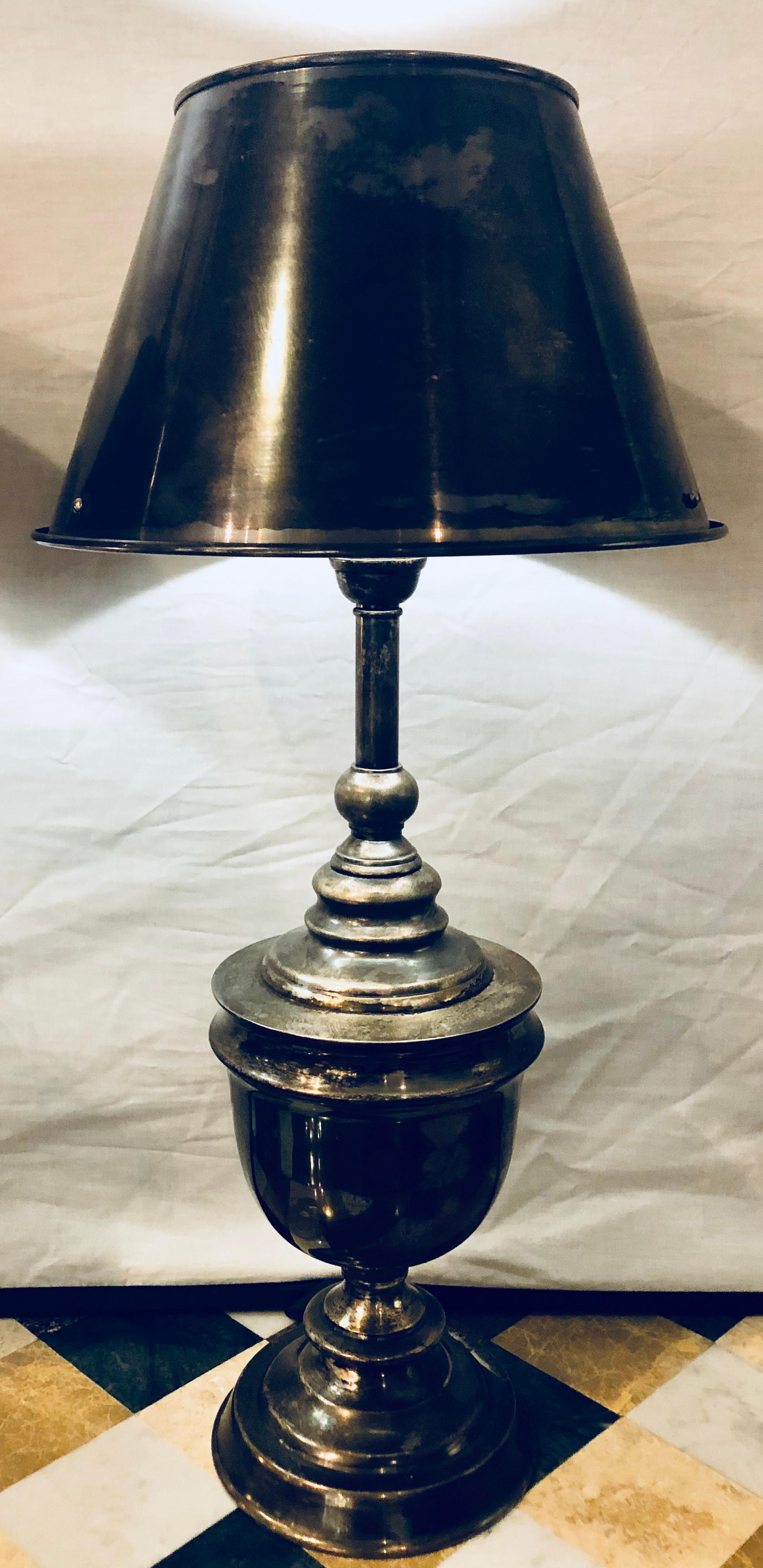 A pair of industrial nickel finish urn lamps with matching shades. This fine pair are weathered in appearance however, should you desire they would certainly polish up wonderfully.