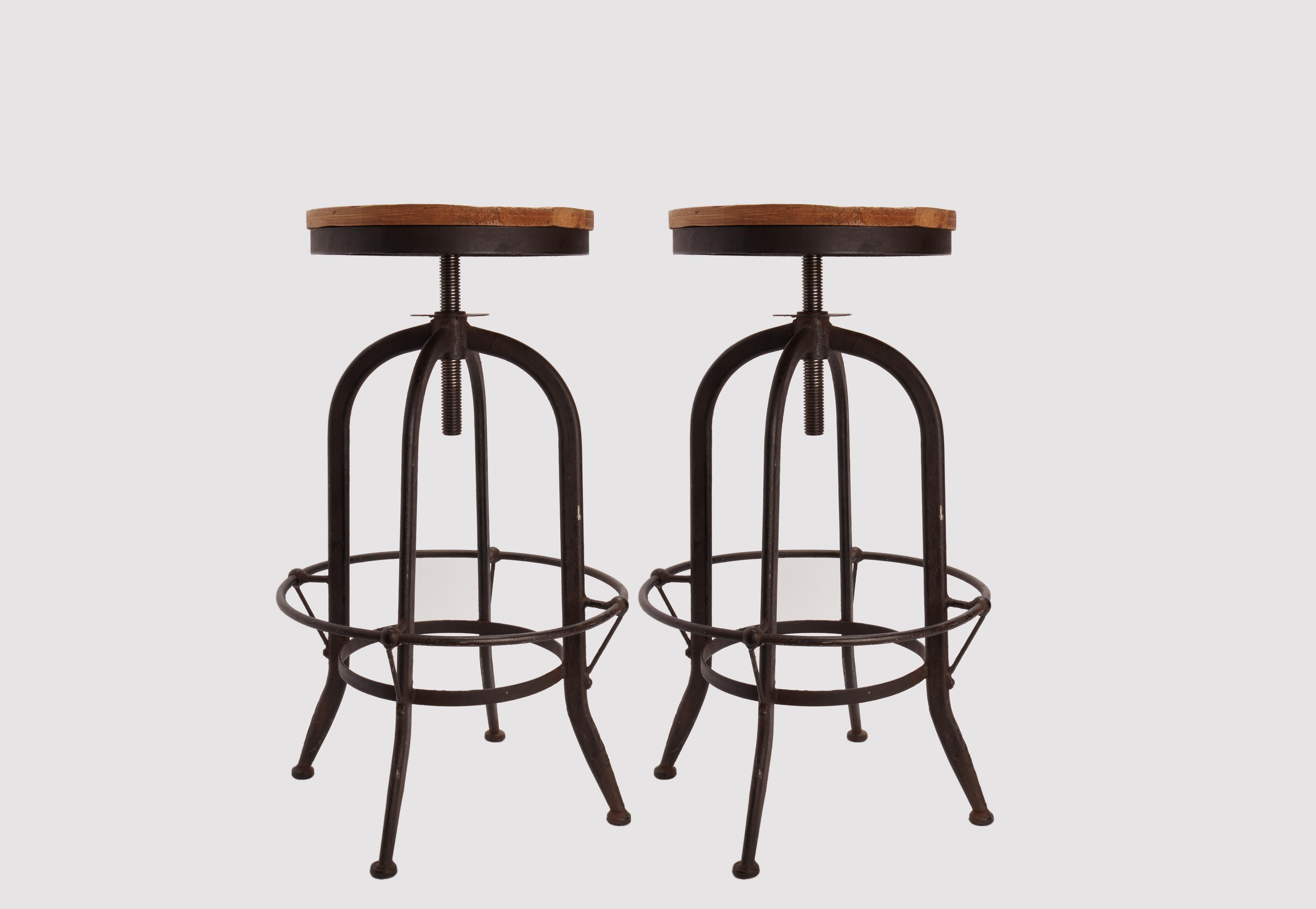 Pair of adjustable stools with footrest for the bistro industry. The 4 legs are made out of tubular iron, black color, and the site is made out of solid wood. Screwing or unscrewing the screw we can adjust the height of the stool.