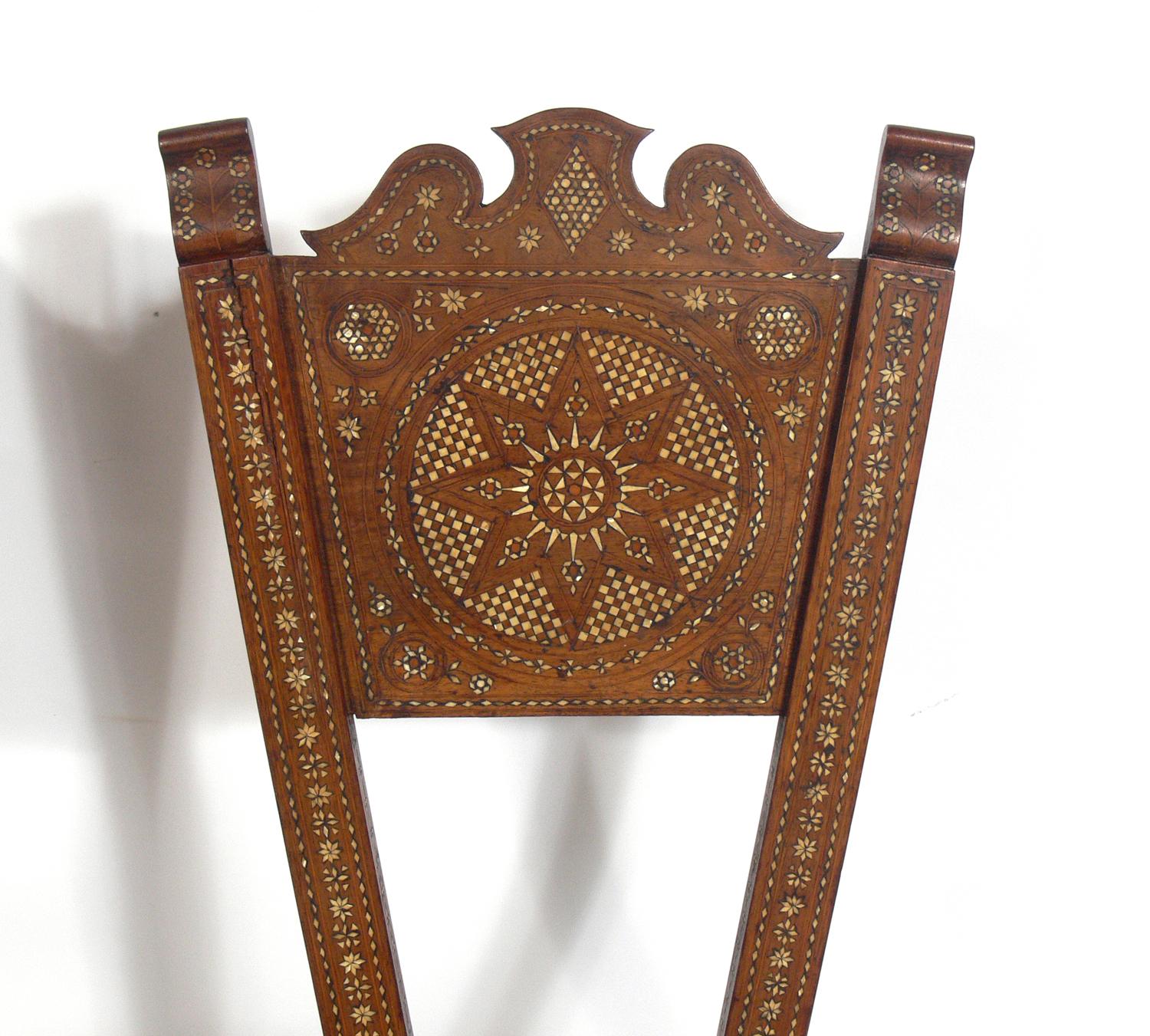 Inlaid Moroccan chair, in the manner of Carlo Bugatti, Moroccan, circa 1950s. They are completely handmade with intricate inlay throughout. They retain their warm original patina.