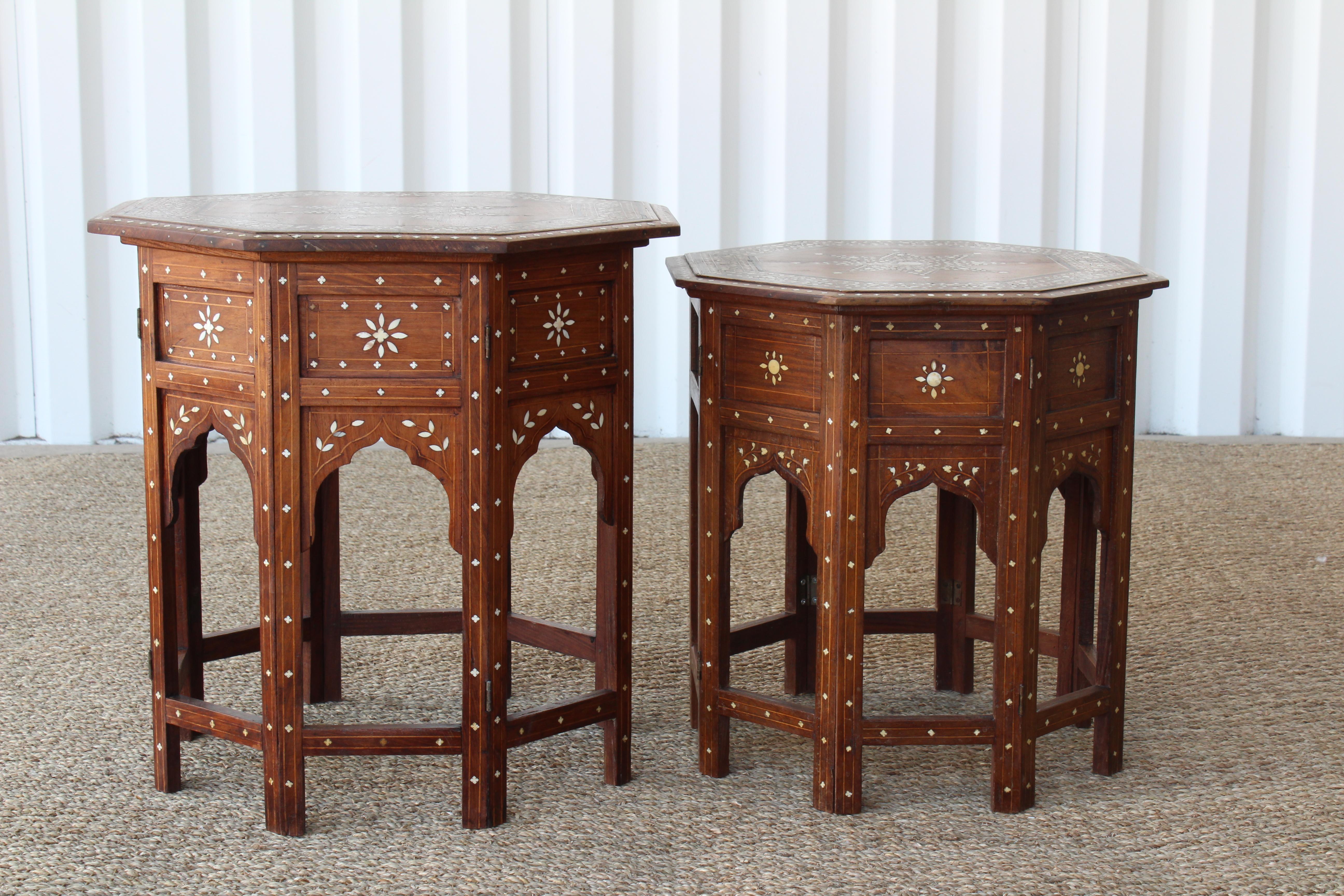 Pair of Syrian inlaid side tables, 1950s. Good condition with some age appropriate wear. Walnut wood has been refinished. Large table is 20 inches high and has a diameter of 21 inches. The smaller table is 18 inches high and has a diameter of 18.5
