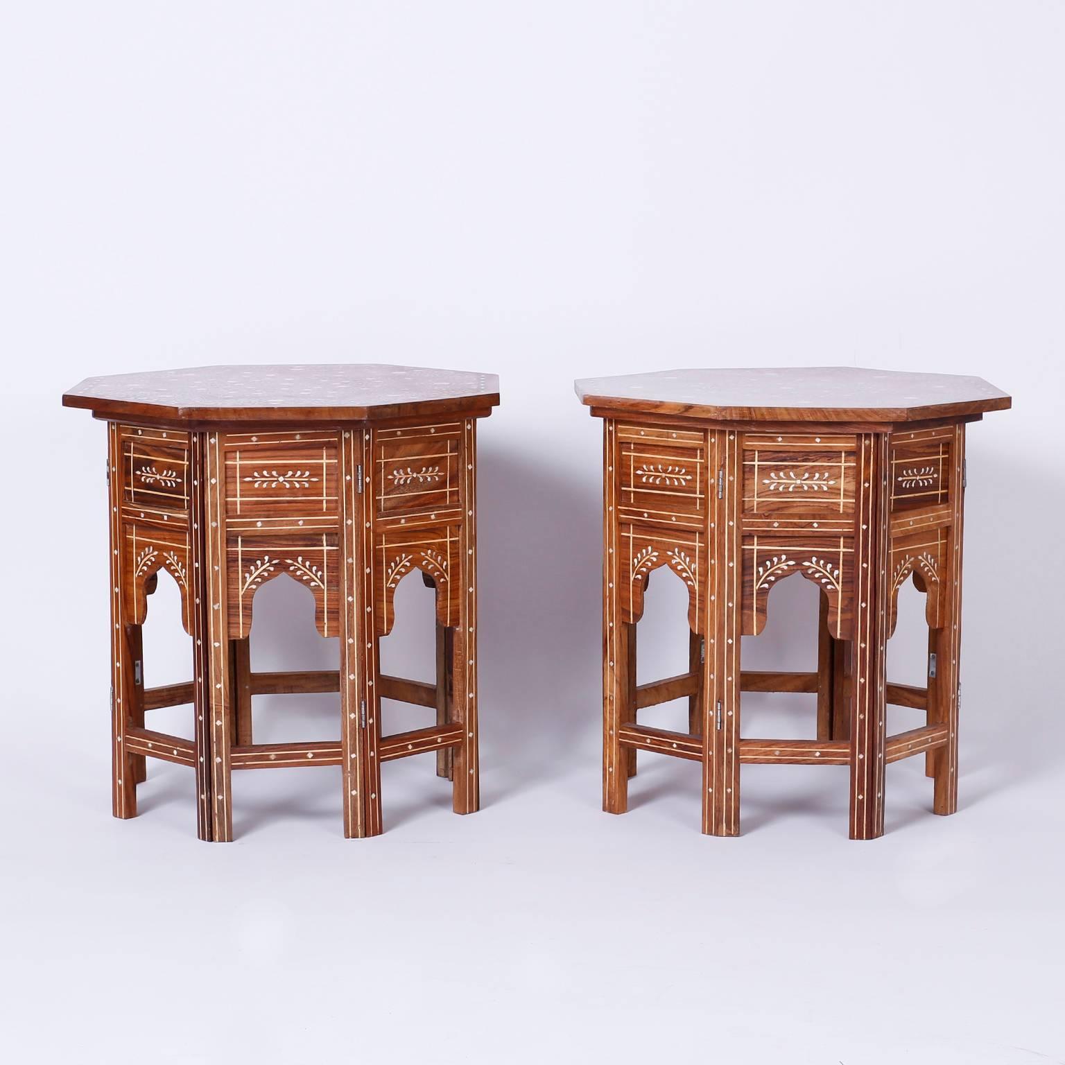 Exotic pair of vintage Syrian mahogany hexagon side or end tables with
elaborate inlaid symbolic floral designs on top over a base with six
Moorish ashes and geometric bone inlays.