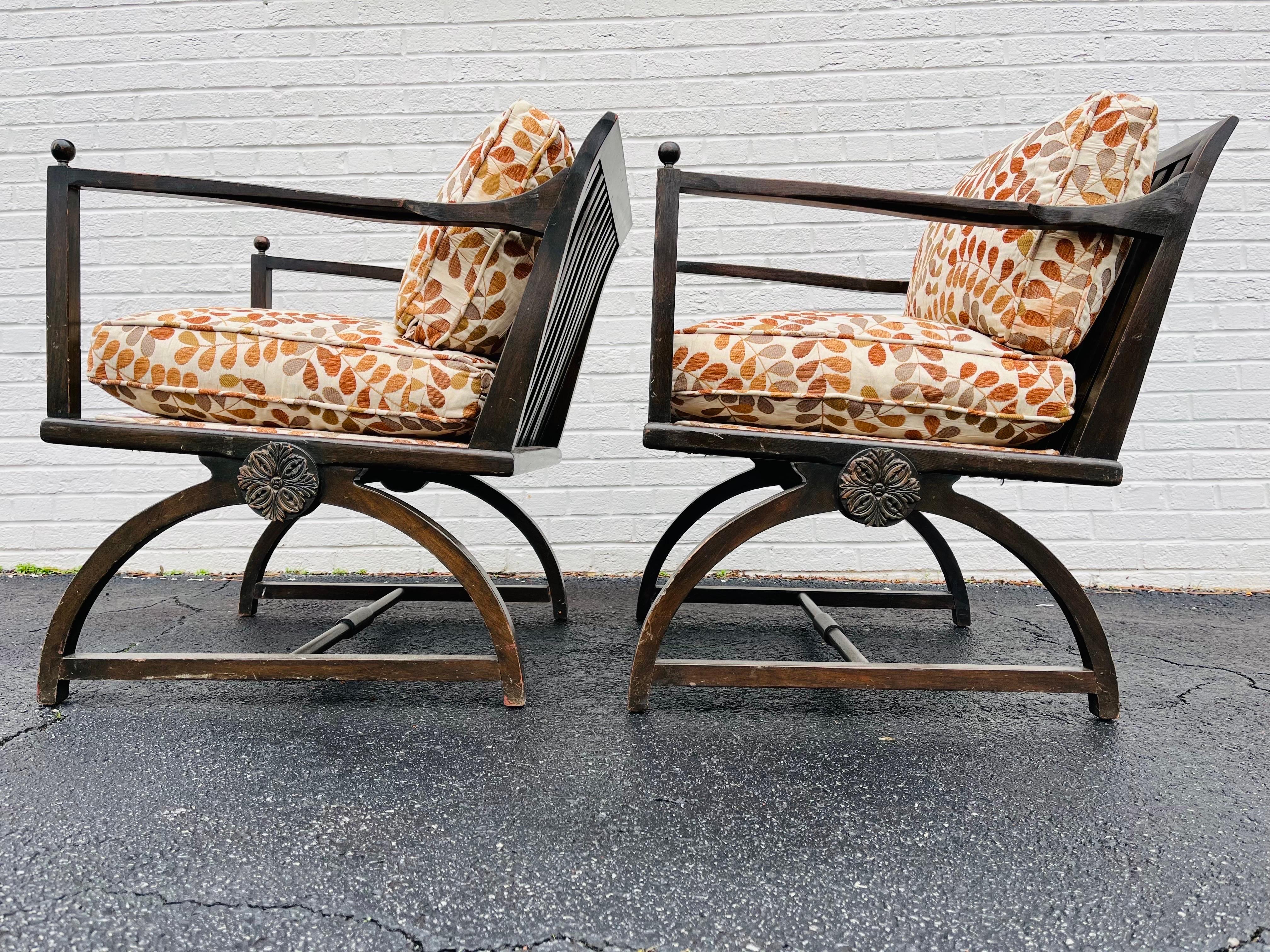 A vintage, possibly antique, pair of wood slat back chairs with a Weiner Werkstatte / Vienna Secession sensibility. This pair of interesting chairs each has a wood slat back, arms culminating in ball finials and a semi circle foot base. There is an