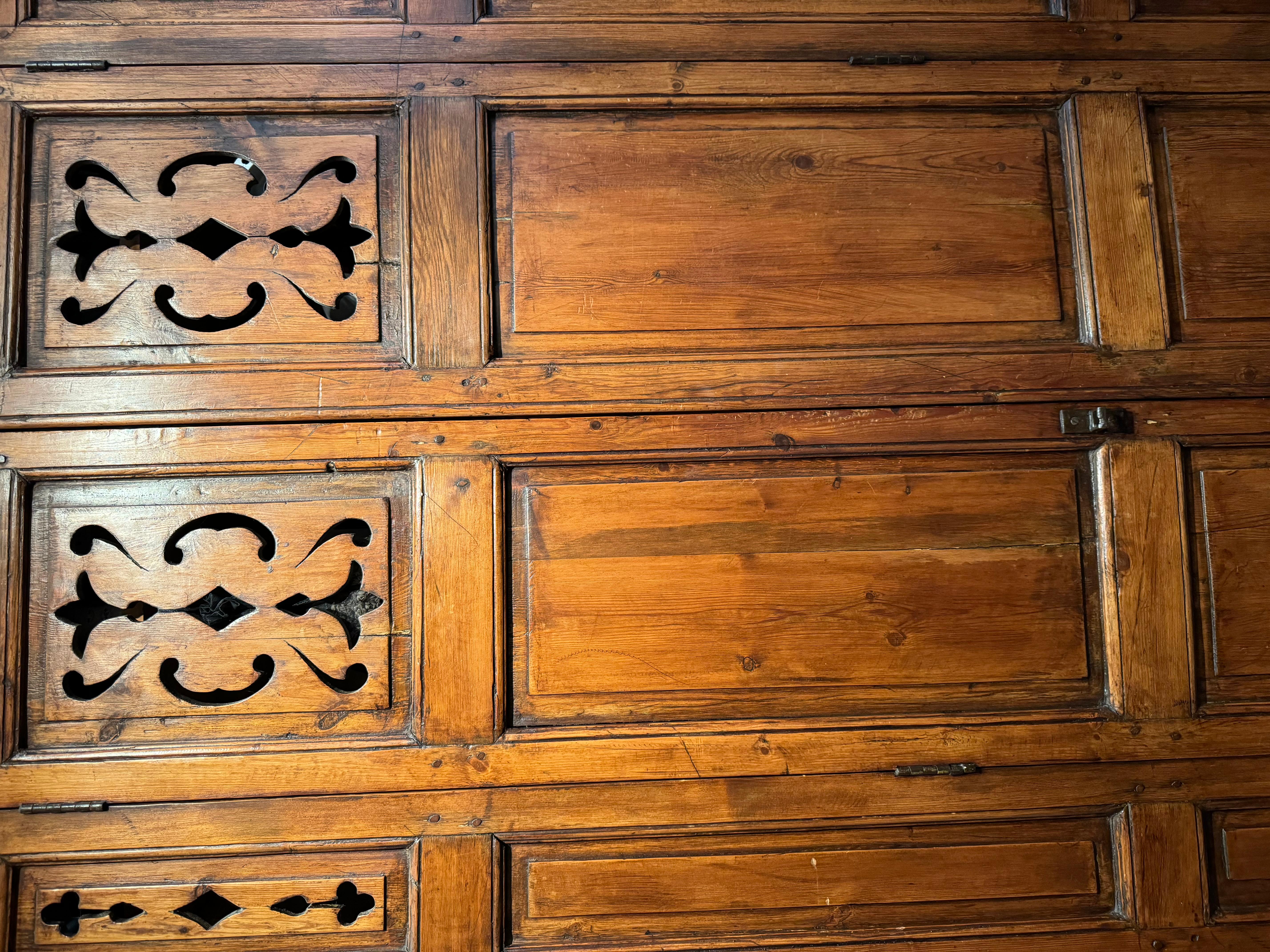 A rare pair of interior wooden shutters (probably fruitwood, or pitchpin?) with hinged jambs. 
Probably from the Savoie region, given the openwork motifs at the top.
France, circa 1830. Possibly earlier. 
201x117 cm  each 
Door size :201x38 cm (