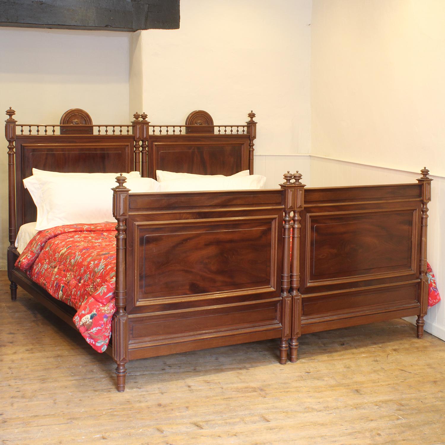 A pair of French Louis XVI style beds from the early Twentieth Century, which interlock to form a wide bedstead. The beds normally stand together to form an 84 inch wide bed, but can be separated to create a pair of 42 inch wide beds.

The price