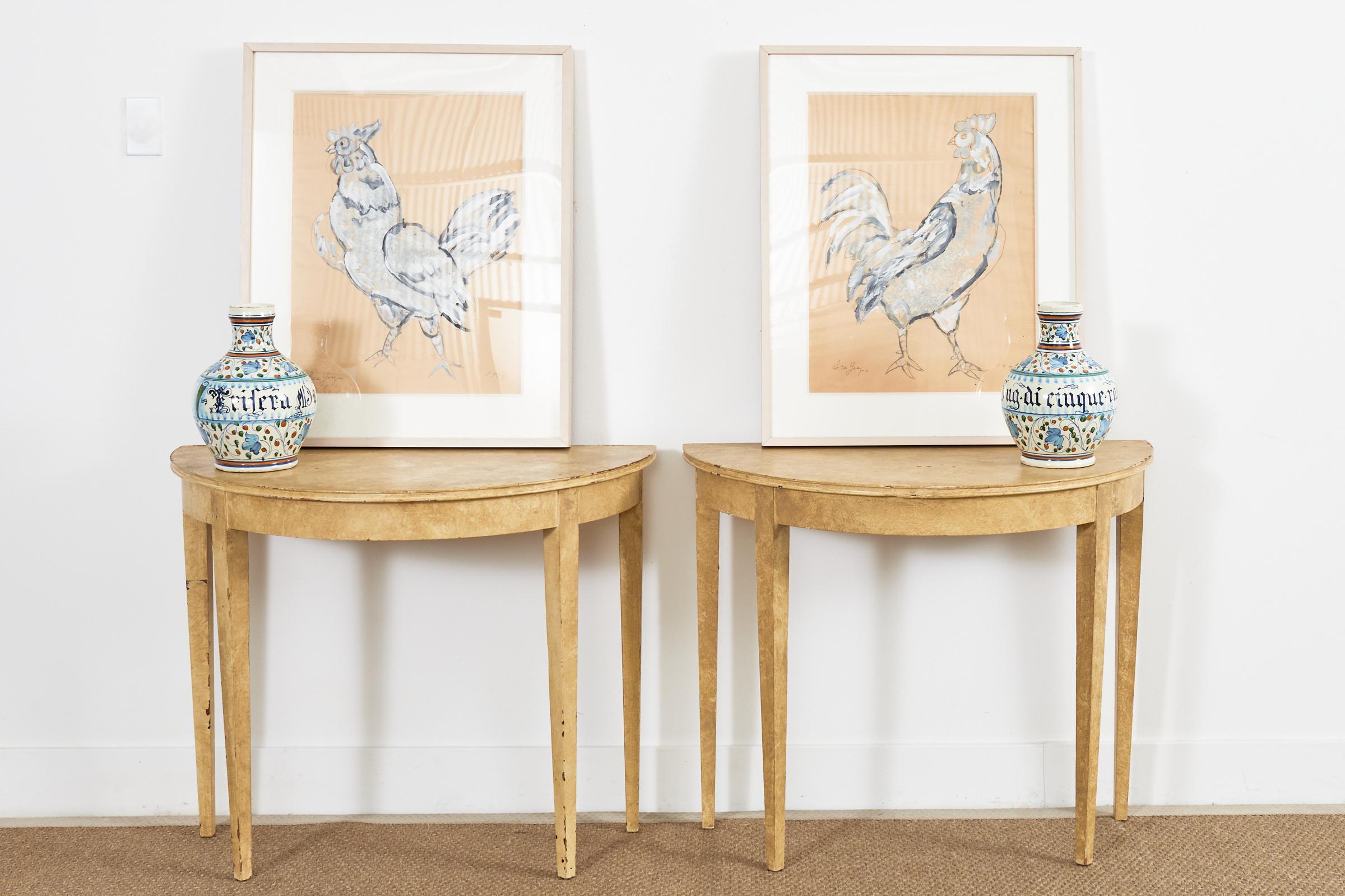 Charming pair of framed paintings of chickens or roosters mounted in acrylic and lacquered wood frames by Ira Yeager (American 1938-2022). Painted on beige Italian paper giving the paintings a country French provincial style he loved so much. Each