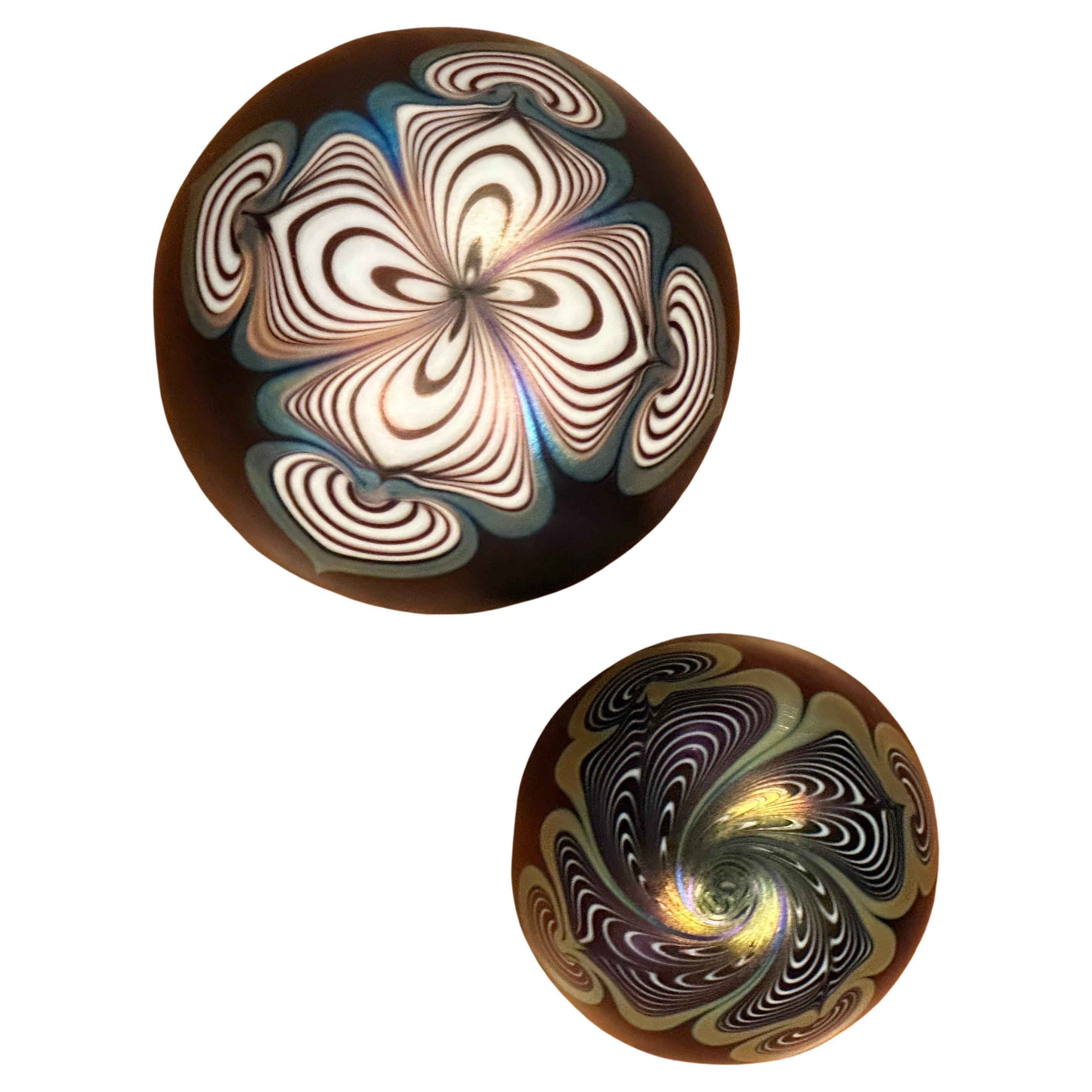 Spectacular pair of iridescent art glass paperweights by Stuart Abelman, circa 1995.  The pieces are in very good vintage condition with no chips or cracks and measures 3.25