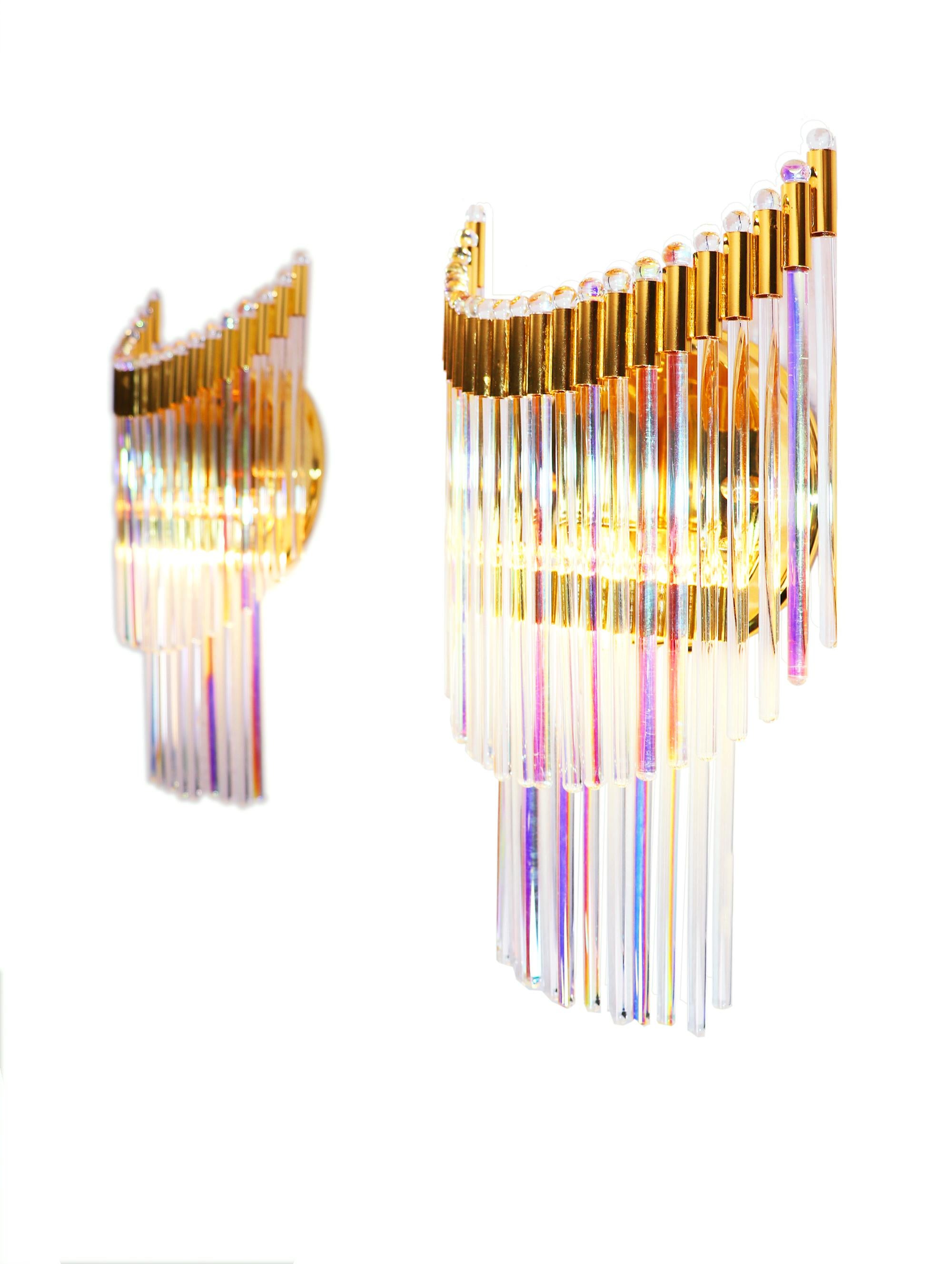 Elegant pair of wall sconces 'Foglie' composed by clear and iridescent hand blown Murano glass rods placed around the gold plated frame to create this spectacular piece. Made by Industria Veneziana Lampadari srl, Italy, 1970s. 

Design: Gaetano