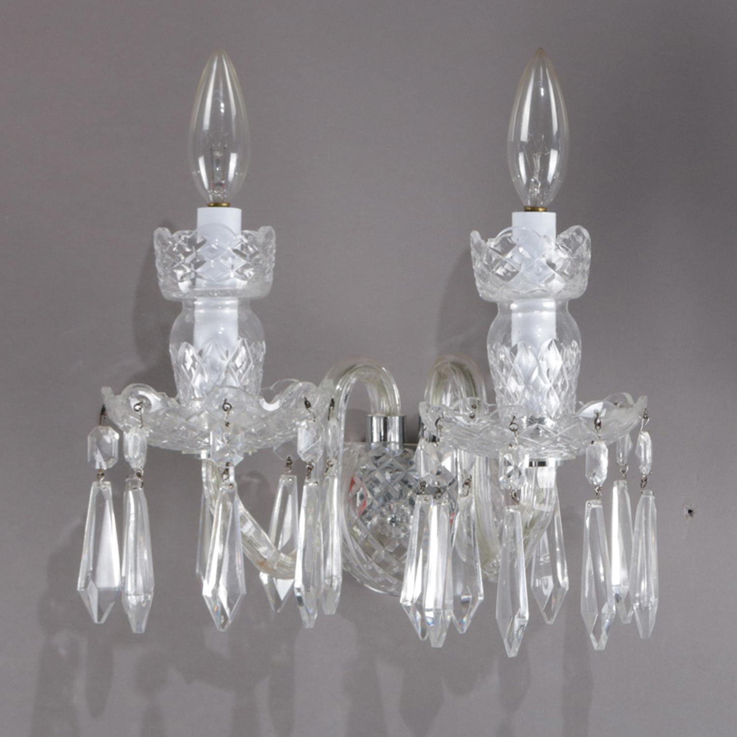 Pair of Irish Waterford Avoca wall sconces feature cut crystal base with S-scroll glass arms terminating in two candle lights with cut crystal casing and with hanging prisms, prisms marked 