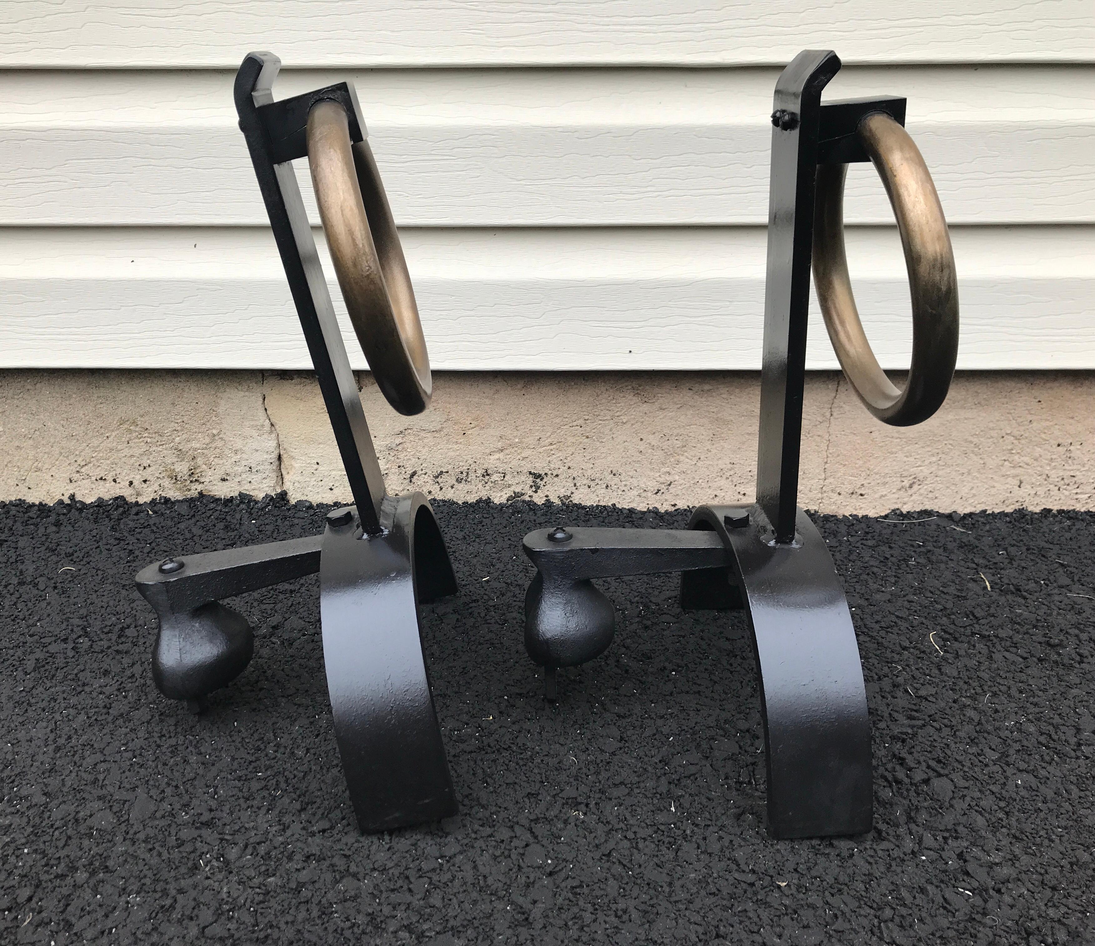 Pair of iron and brass andirons in the style of Jacques Adnet, great size and scale.