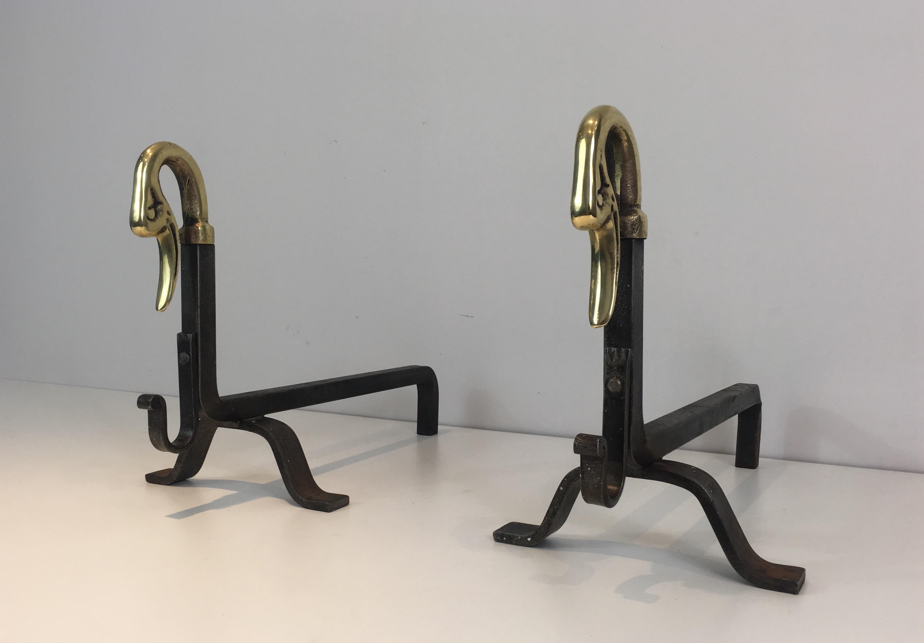 This pair of andirons are made of iron with bronze duck heads. This is a French work attributed to Maison Jansen. Circa 1940 