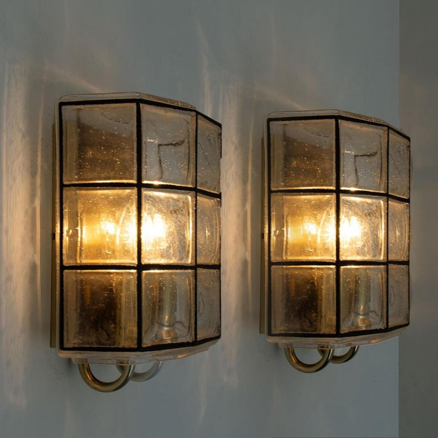 This beautiful and unique pair of hand blown glass wall lights were manufactured by Glashütte Limburg in Germany during the 1960s, (late 1960s or early 1970s).

Beautiful craftsmanship. These midcentury vintage lights feature handmade, elaborate