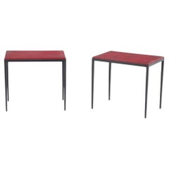 Pair of iron and deep red leather end tables in the manner of Jean-Michel Frank.