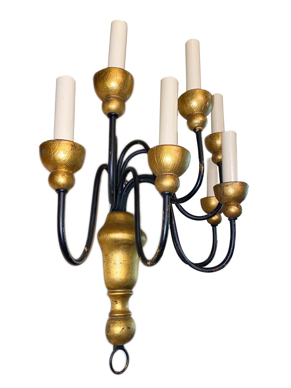Pair of circa 1940's French seven-arm wrought iron and giltwood sconces.

Measurements:
Height: 17.5