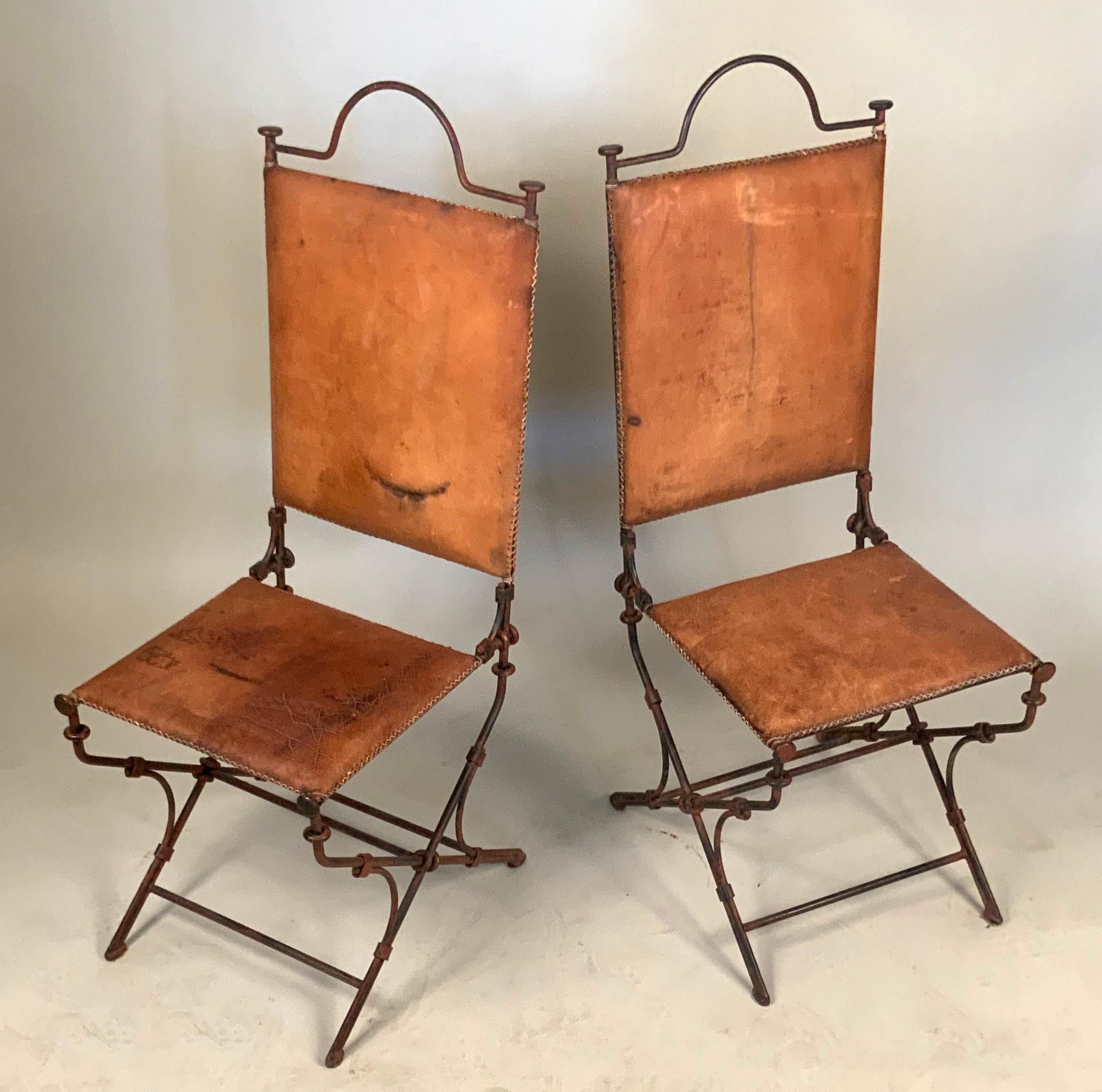 A very handsome pair of vintage high back chairs designed by Ilana Goor, with wrought iron frames and leather seats and backs. Beautiful design and details, and very well made.