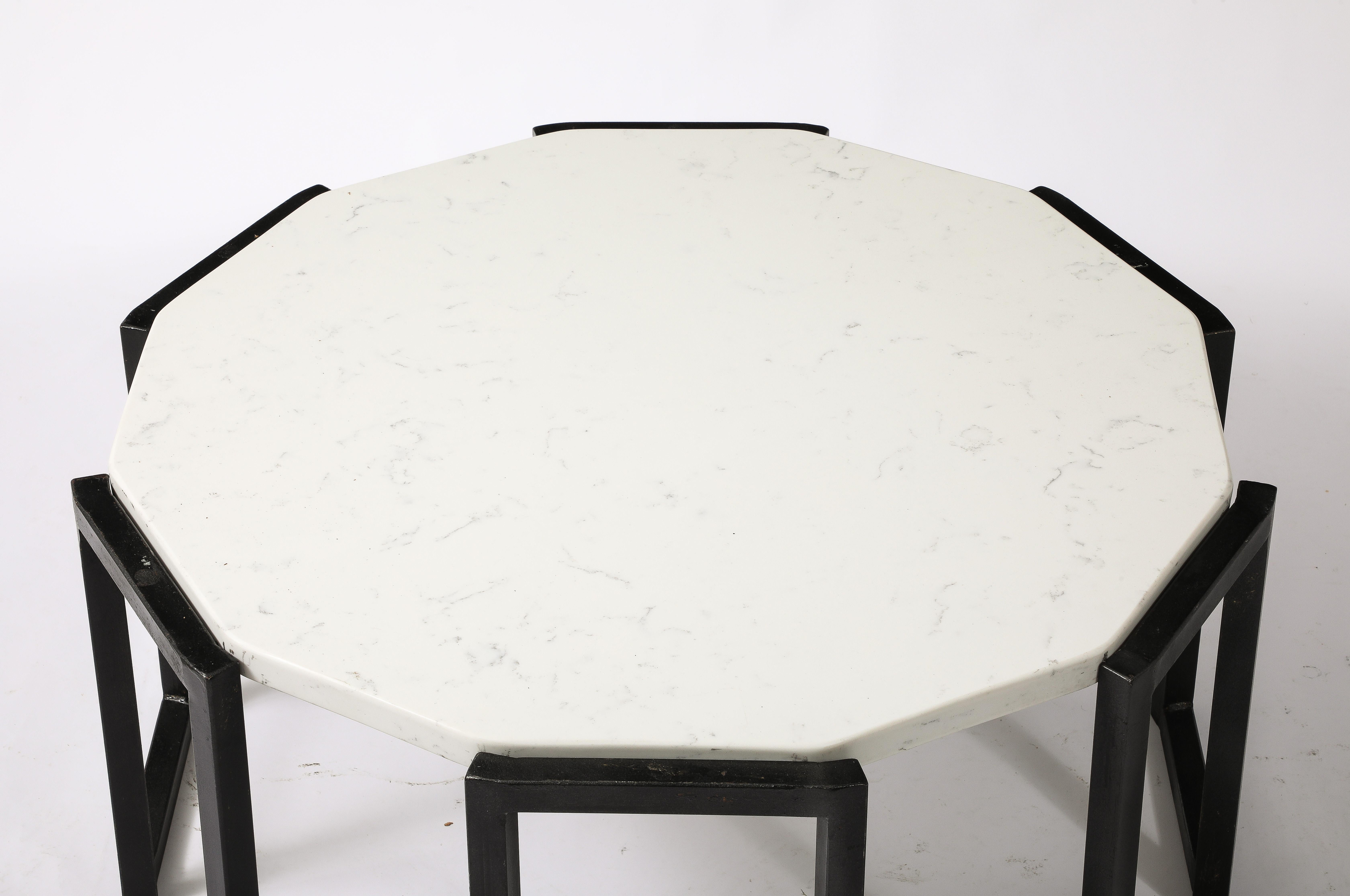 Pair of Octagonal table in a crenelated form with white marble tops.