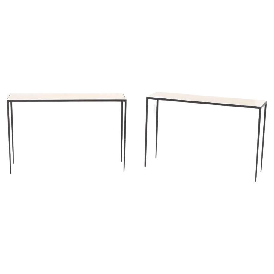 Pair of iron and parchment console tables having tapered legs