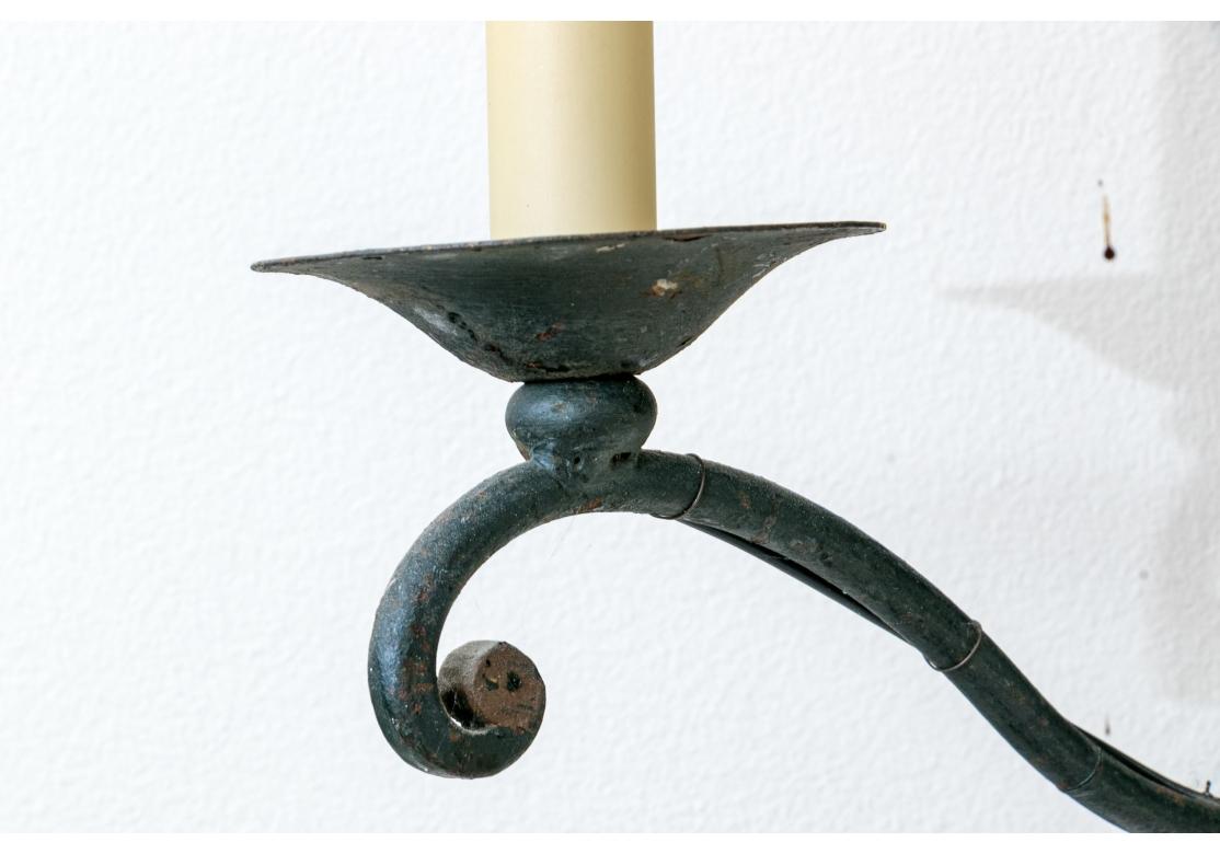 Hollywood Regency Pair Of Iron And Tole Two Light Wall Sconces For Sale