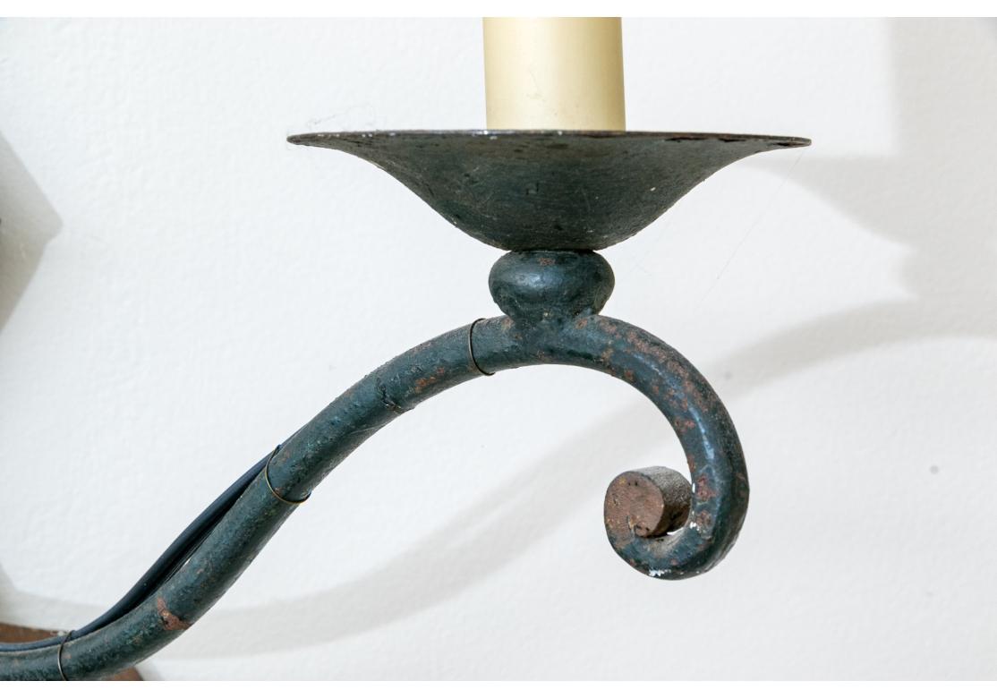 Pair Of Iron And Tole Two Light Wall Sconces In Distressed Condition For Sale In Bridgeport, CT
