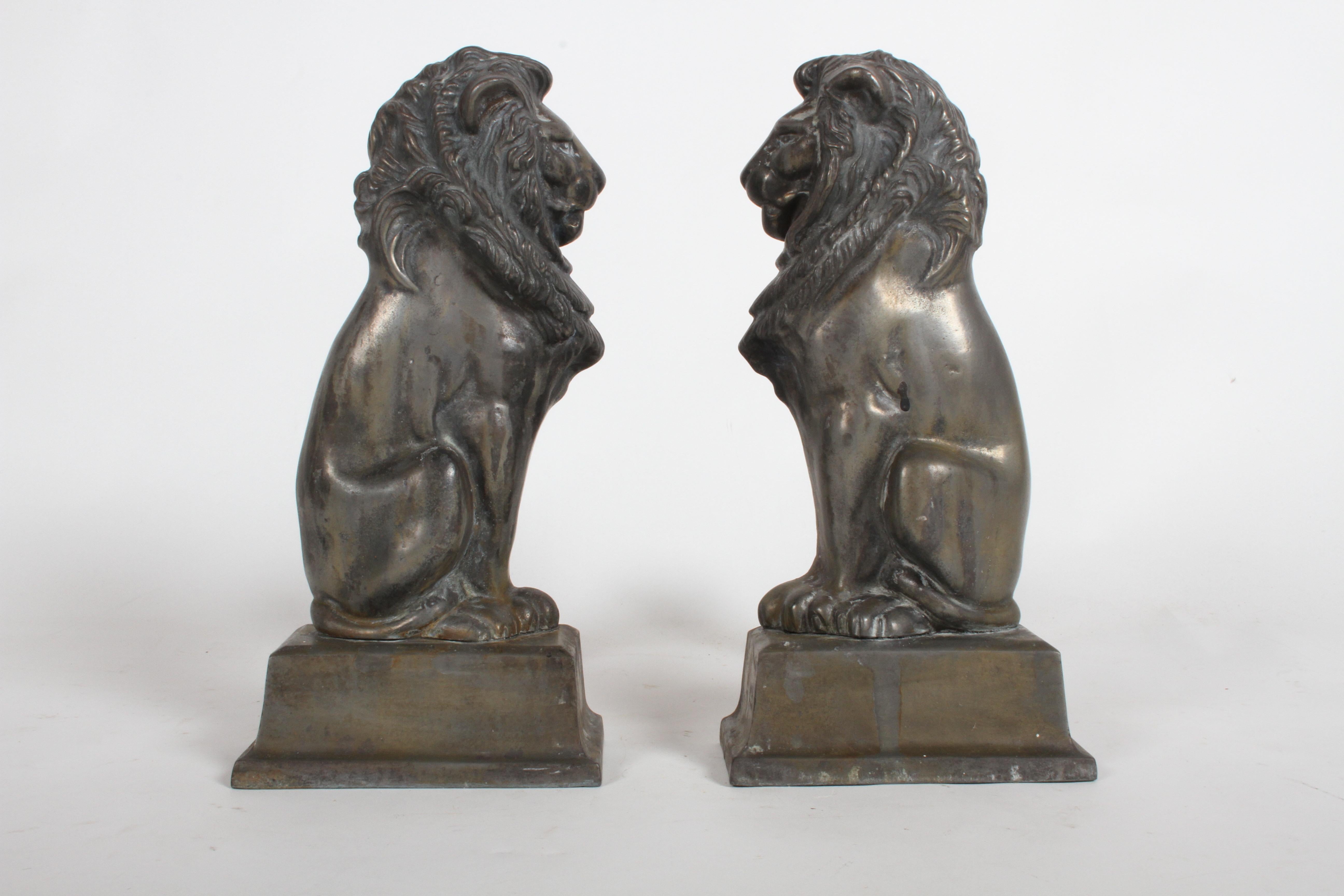 A wonderful pair of cast iron andirons or fire dogs modeled as lions standing on an integral plinth base after sculptor Alfred Stevens (1817-1875. Possibly cast by D. Brucciani and Co. Purchased from a mansion in Kingsbury Place, an historic private