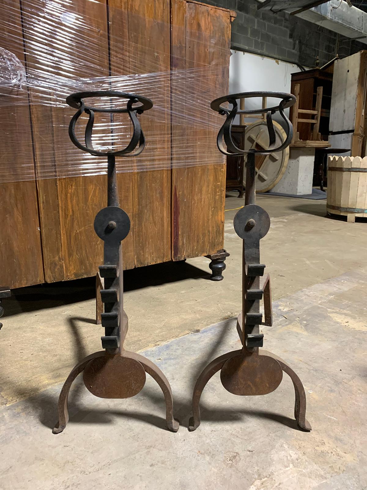 Pair of iron andirons with port warmers and roll bar supports, circa 1900.